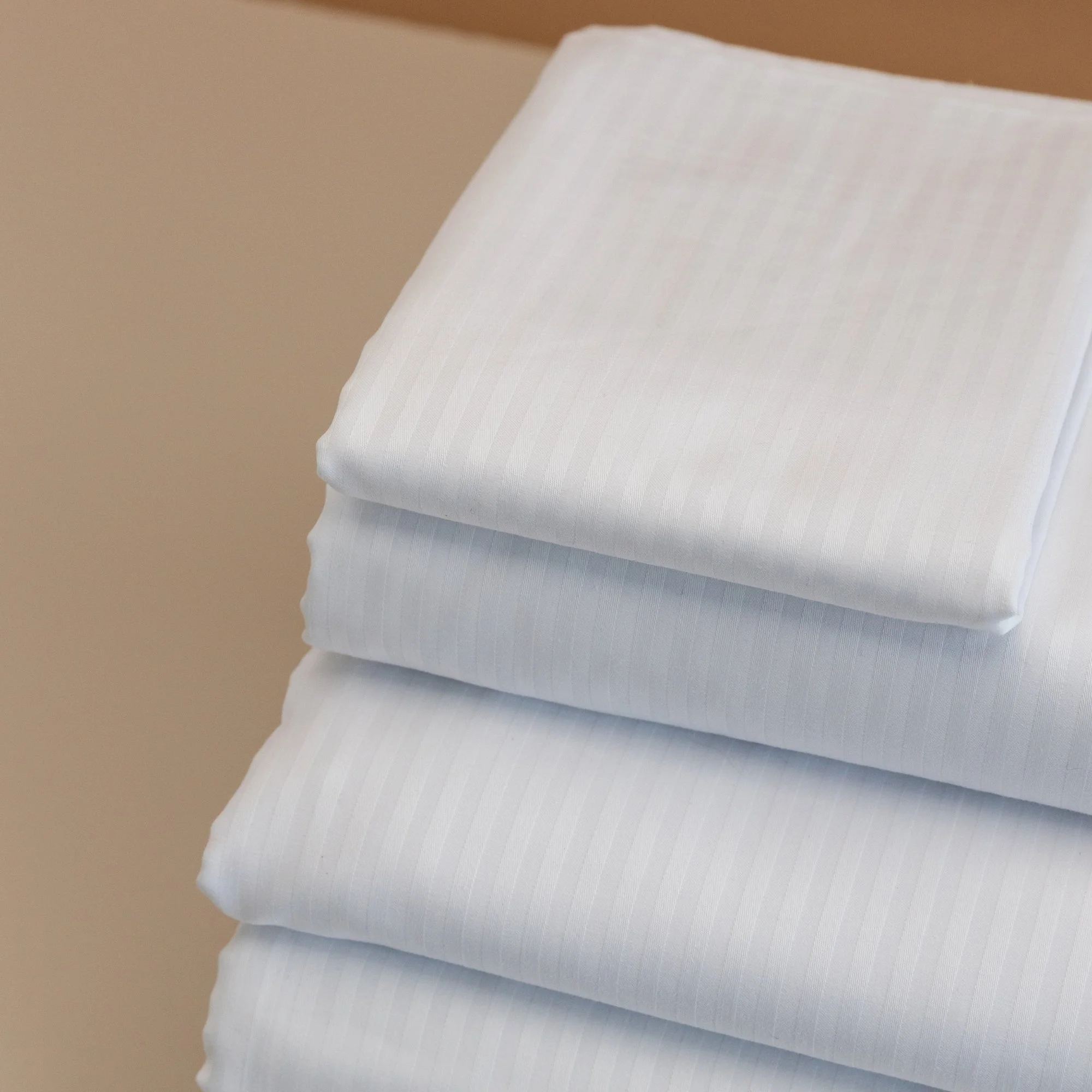 Stack of folded white 4mm Rutherford Striped Sheet set.
