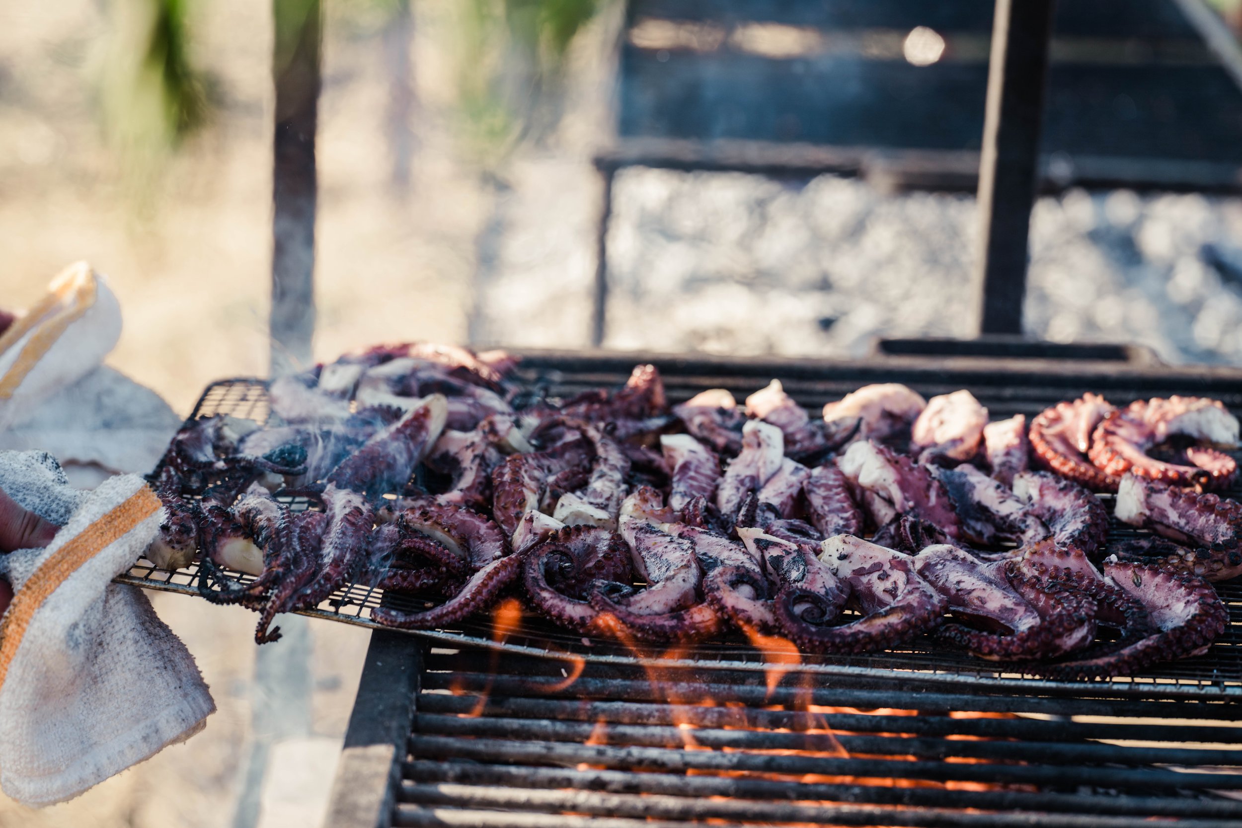 Octopus being cooked over an open flame