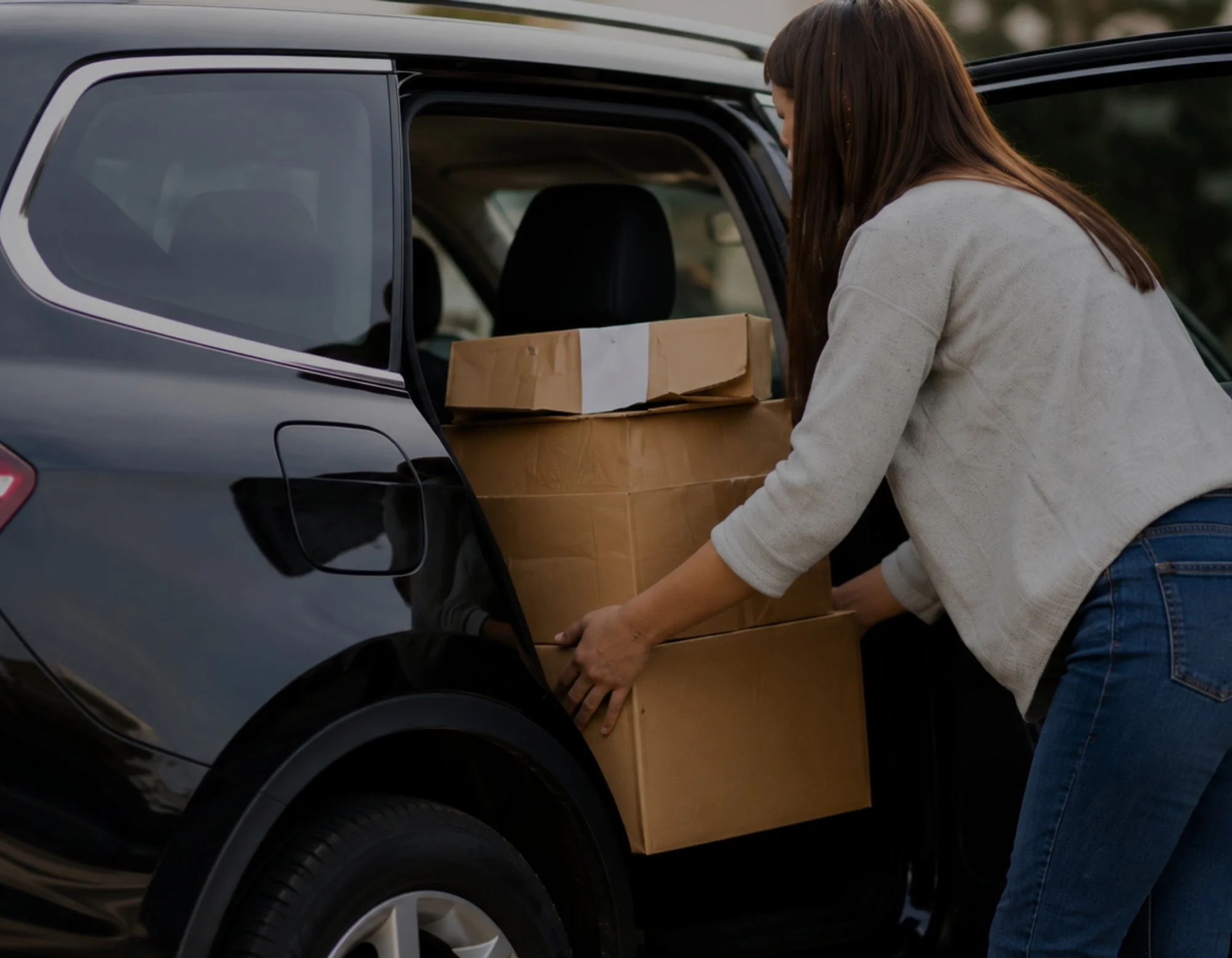 A woman loading her click and collect into her car at Home+ McGraths Hill.