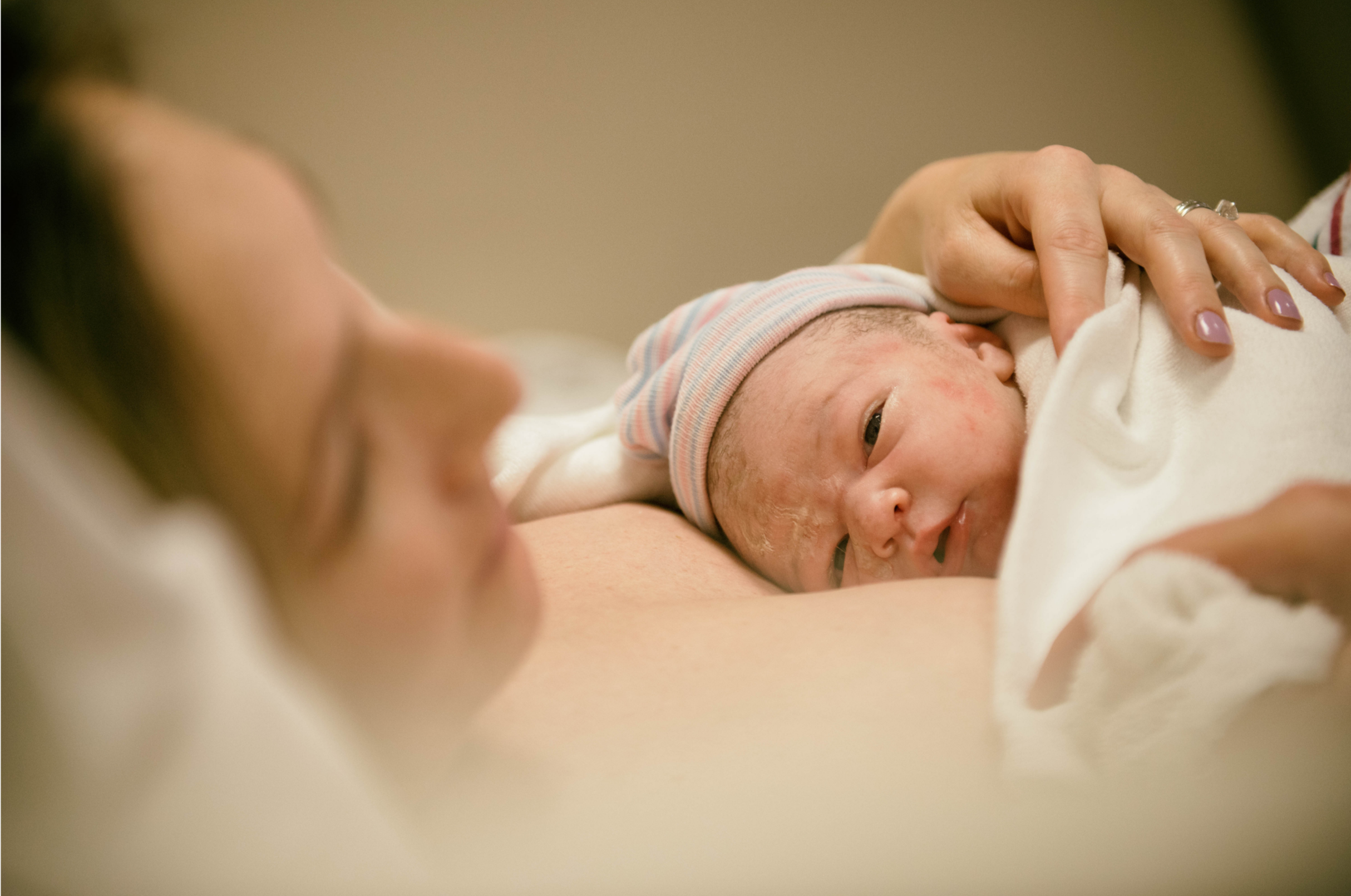 Newborn baby resting skin-to-skin immediately after birth.