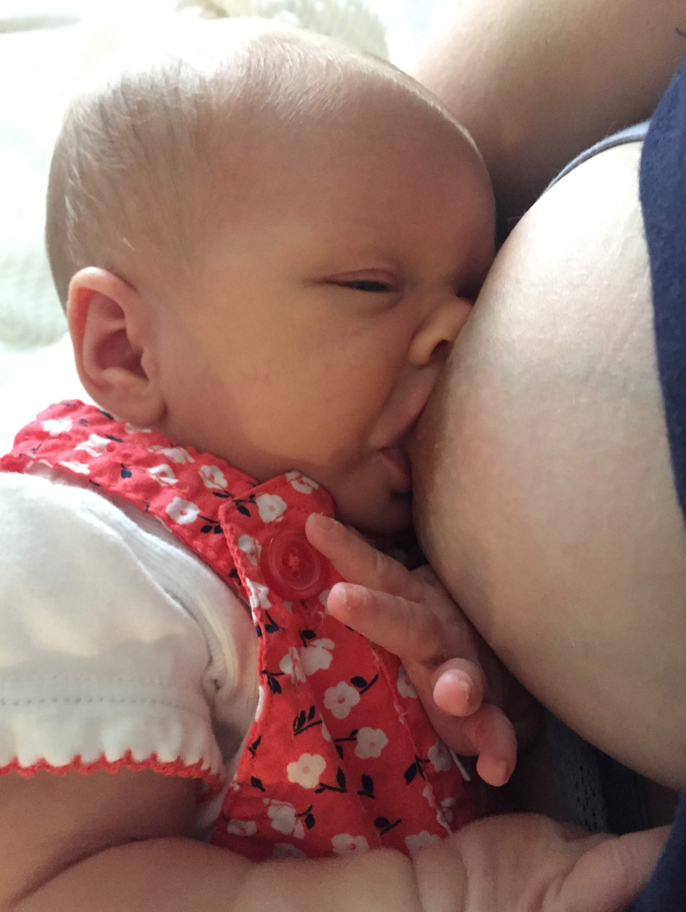 Baby breastfeeding during a nursing session.