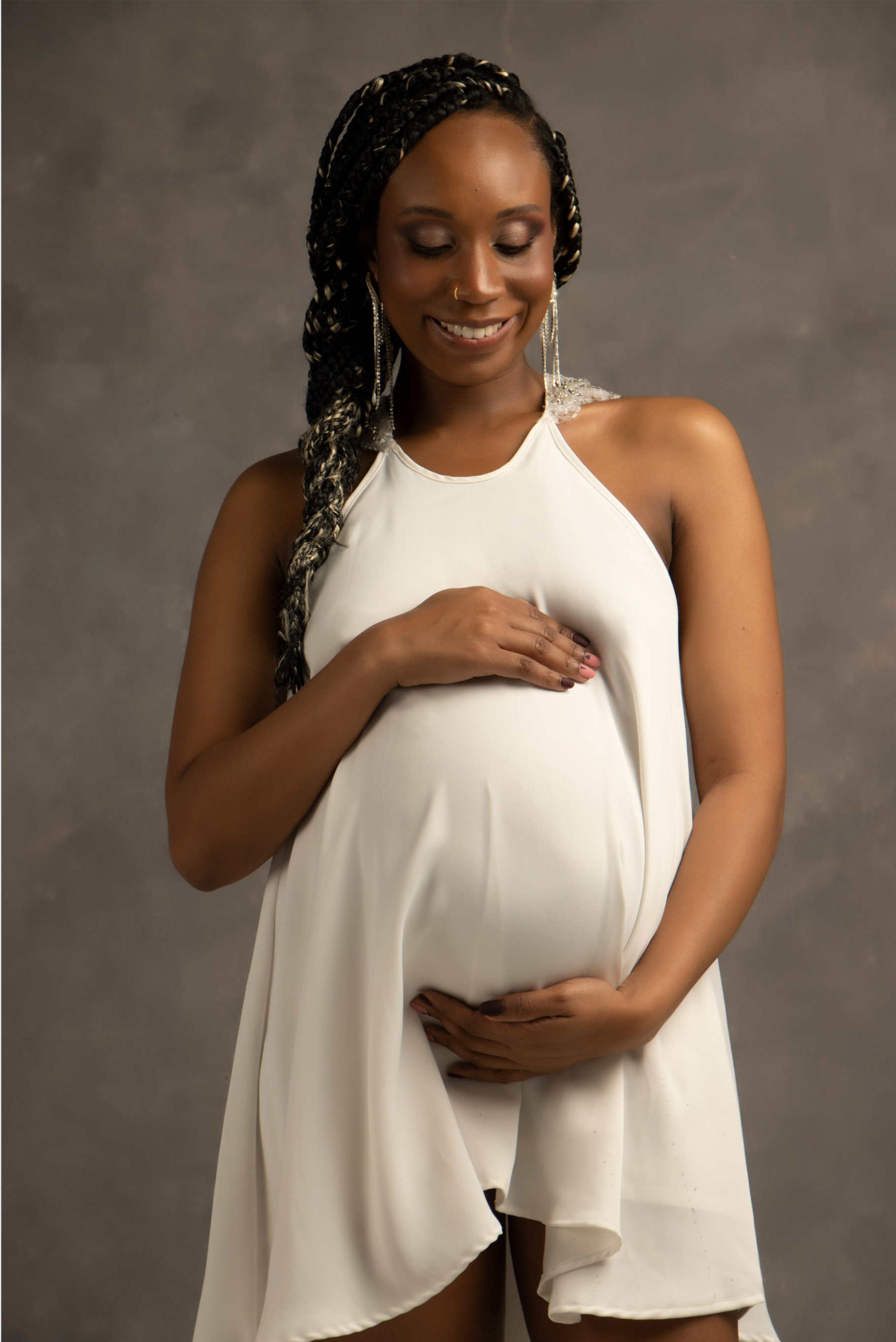 Pregnant person cradling their belly.
