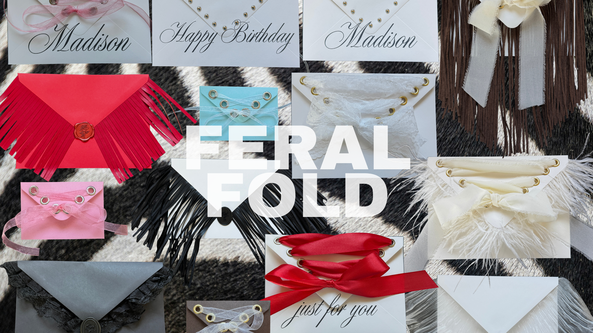 Various decorative envelopes and bookmarks with ribbons and feathers, with labels including "Madison," "Happy Birthday," and "just for you." The background appears to be a black and white patterned surface.