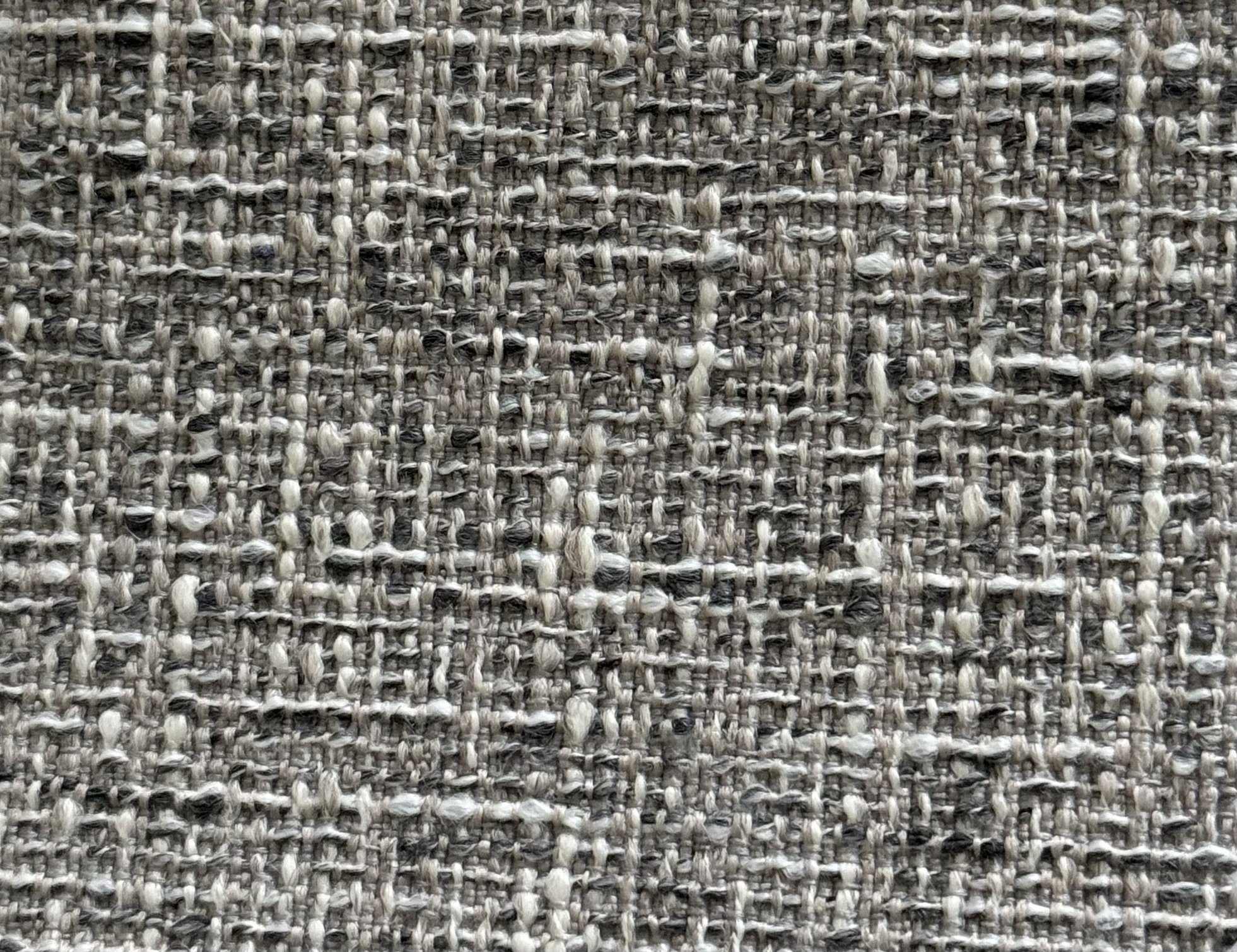 Close-up of woven beige and black textured fabric.