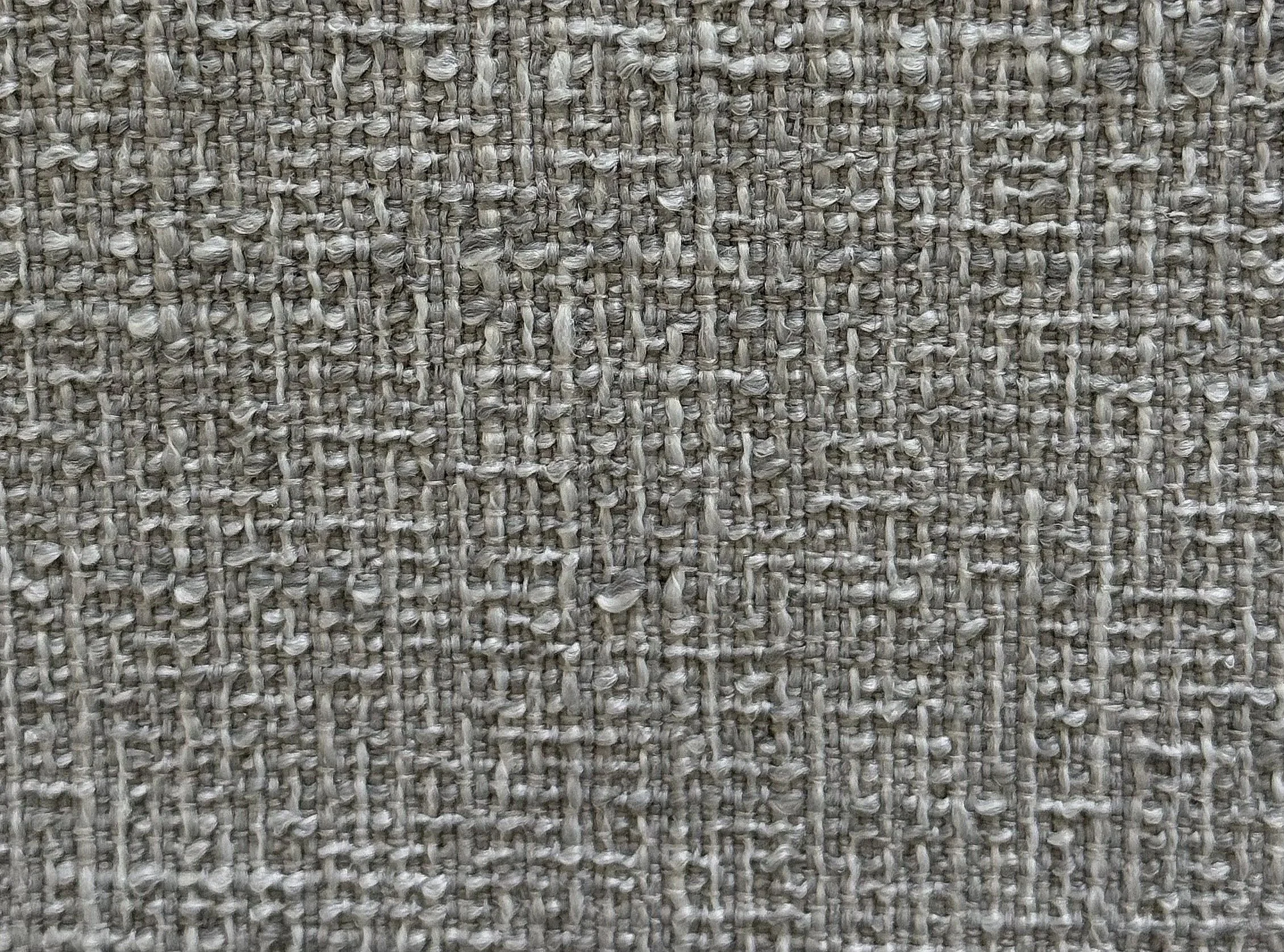 Close-up view of a textured woven fabric in beige and gray tones.