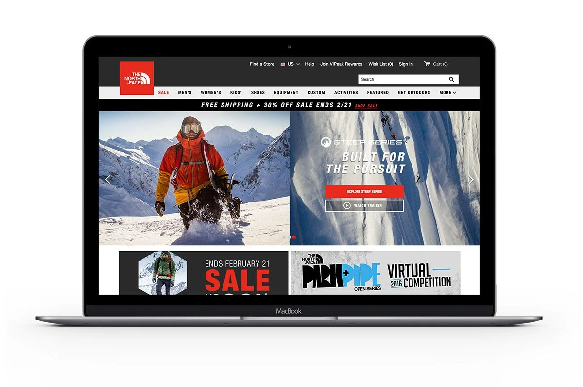 Online store homepage for The North Face, featuring winter outdoor gear and apparel, with mountain scenes and a sale announcement.