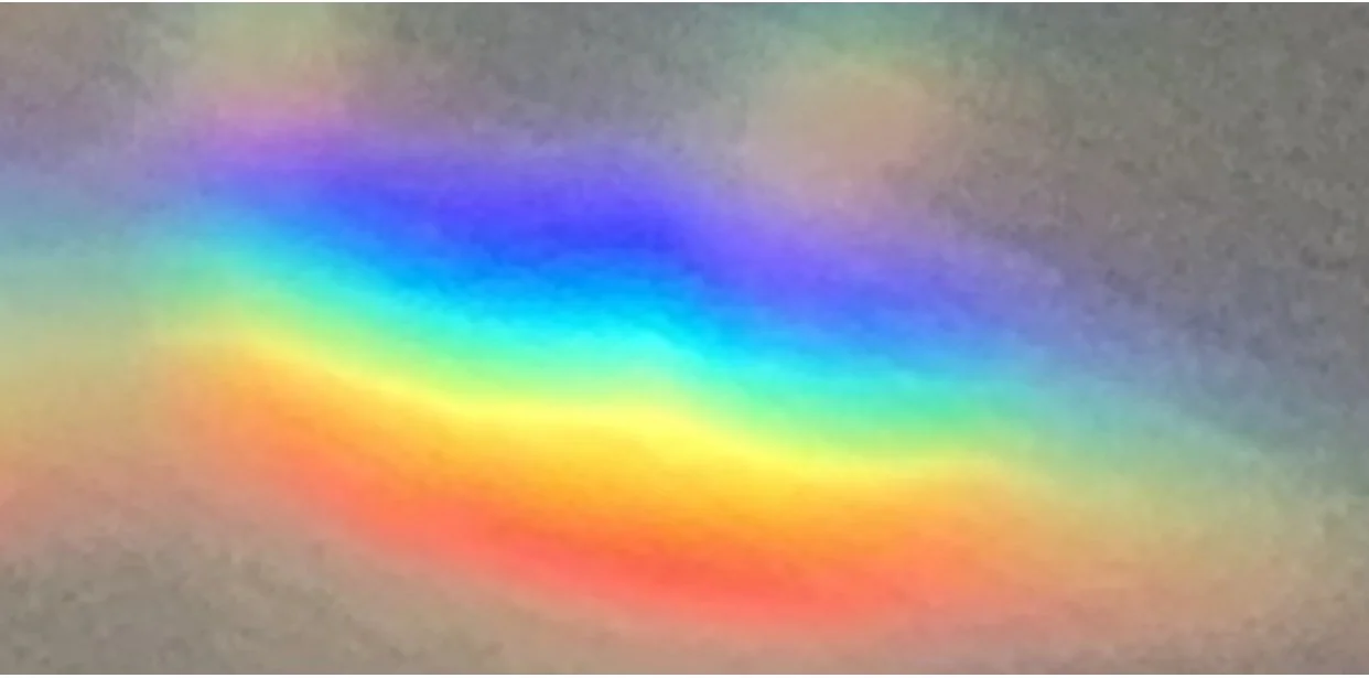 Close-up of colorful rainbow optical illusion or light reflection on a surface