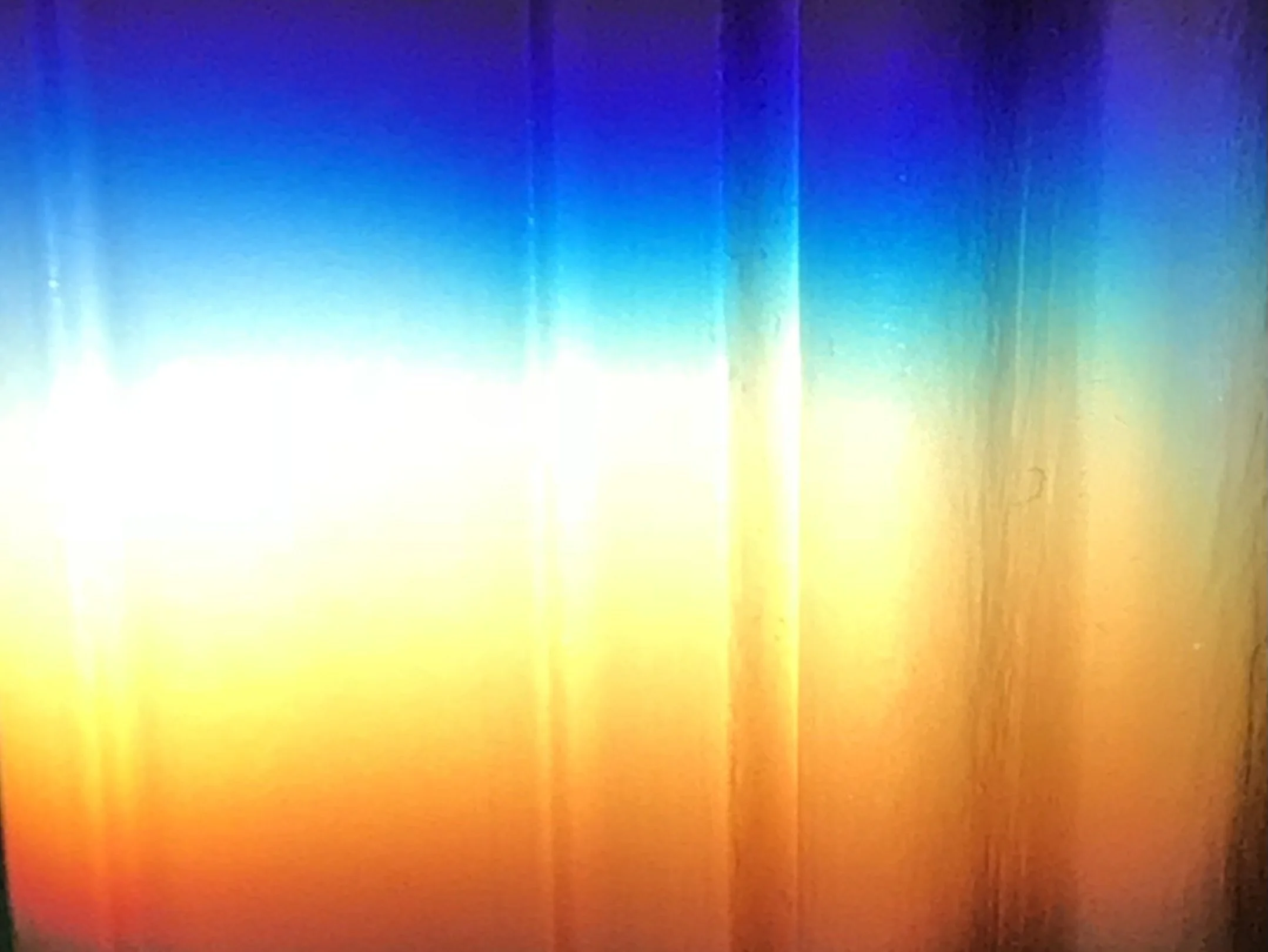 Colorful gradient background with vertical stripes, transitioning from yellow at the bottom to blue at the top.