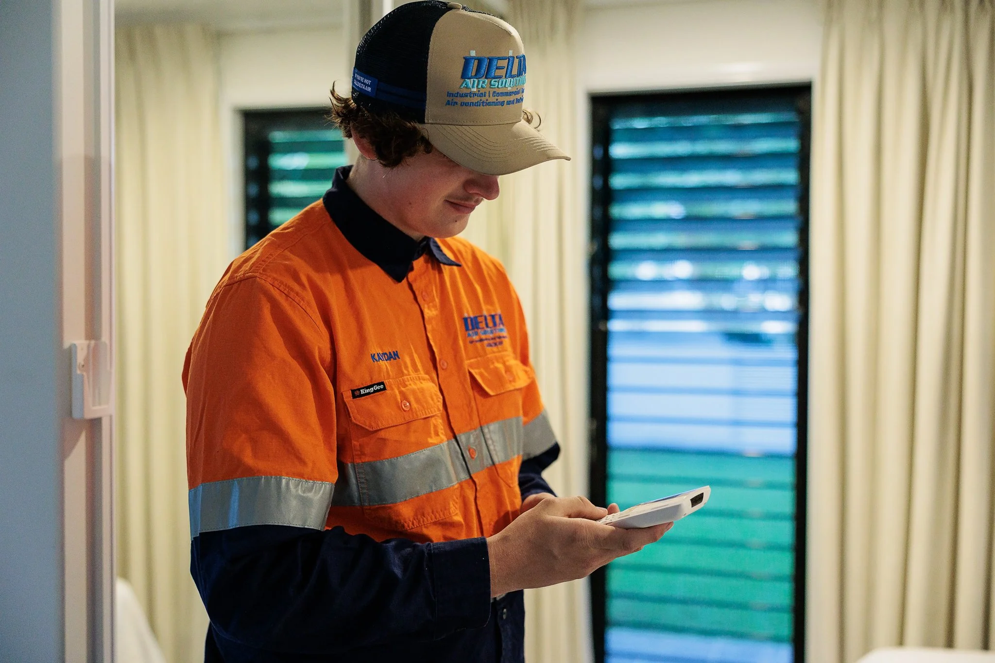 Air conditioning technician inspecting domestic remote control