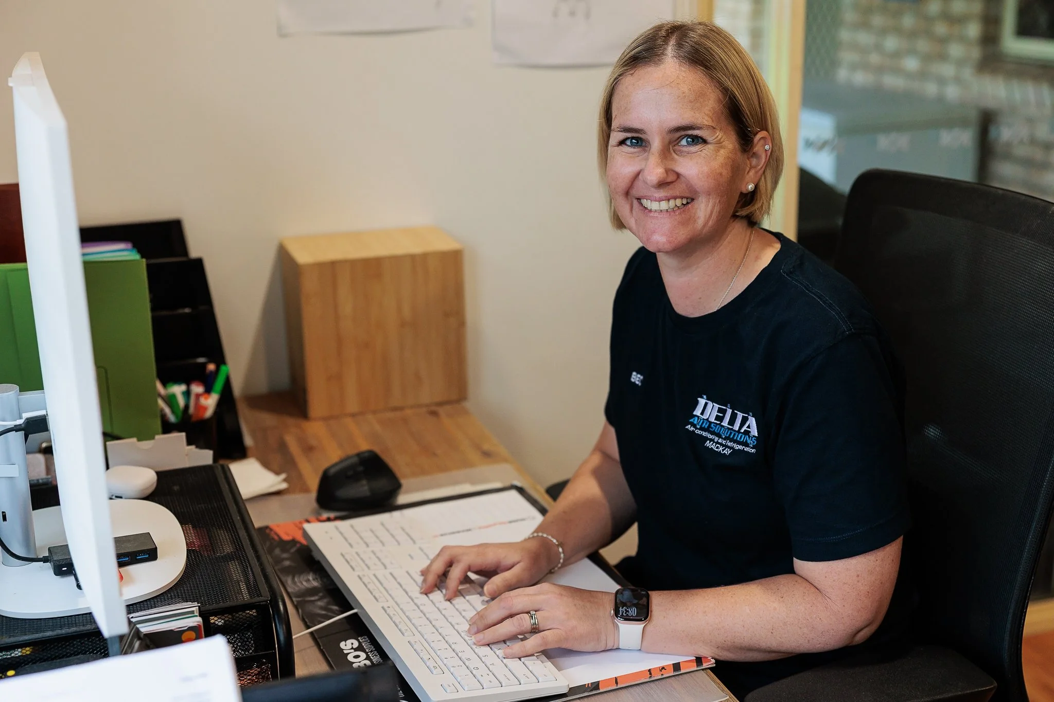 Delta Air Solutions co-owner Bec working at the computer