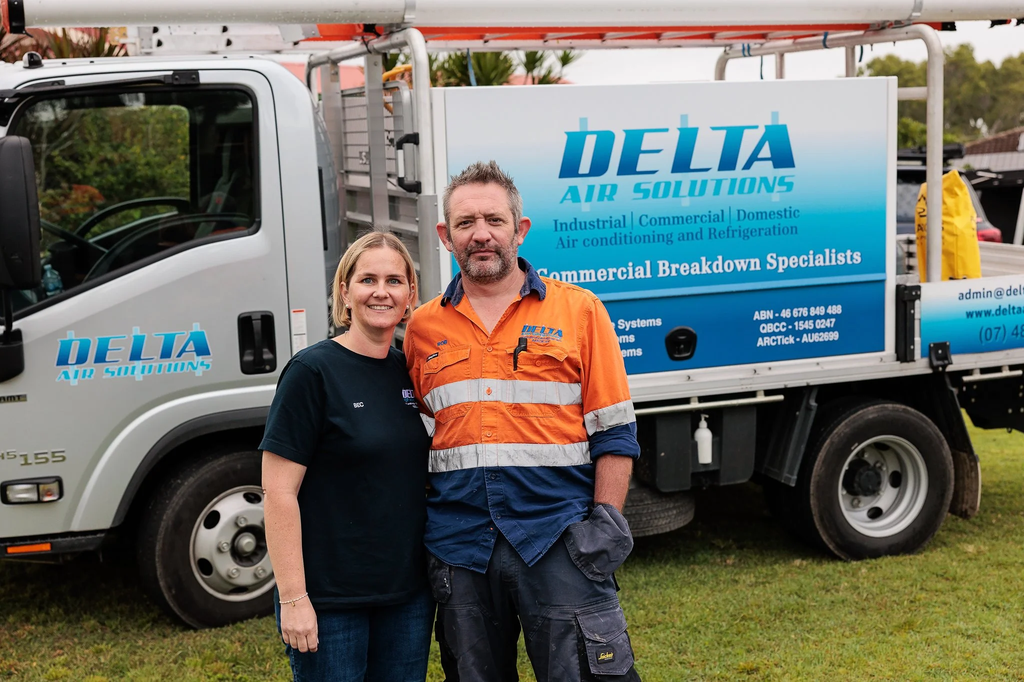 Delta Air Solutions Mackay local owners Rob & Bec in front of branded vehicle