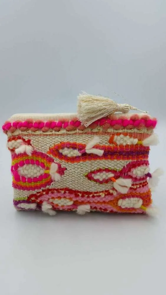 Colorful, embroidered clutch with a tassel on top.