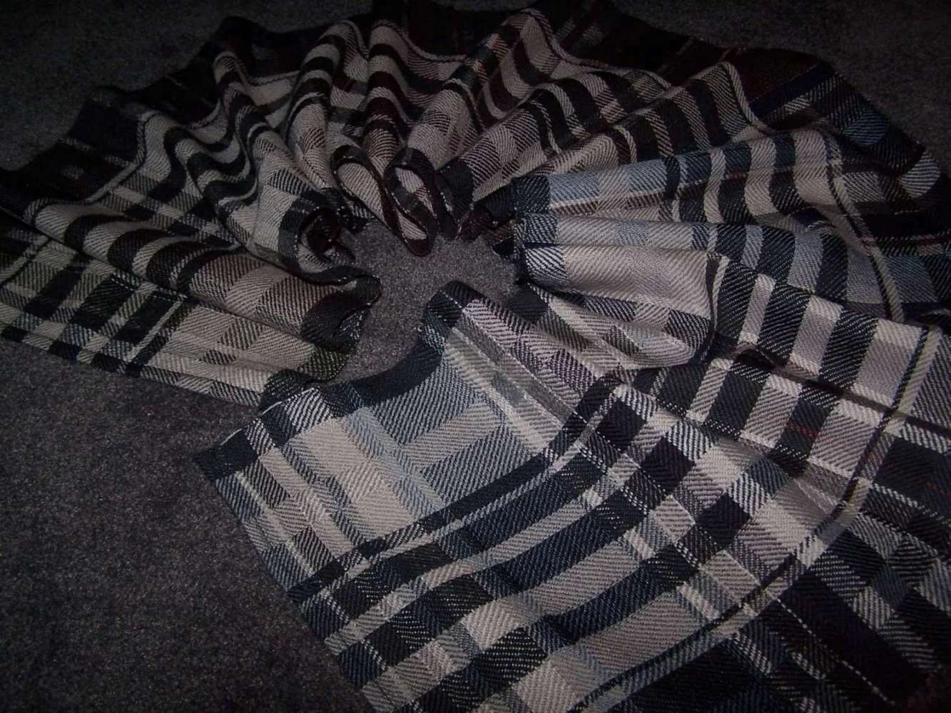 Black and white plaid fabric spread on a dark surface.