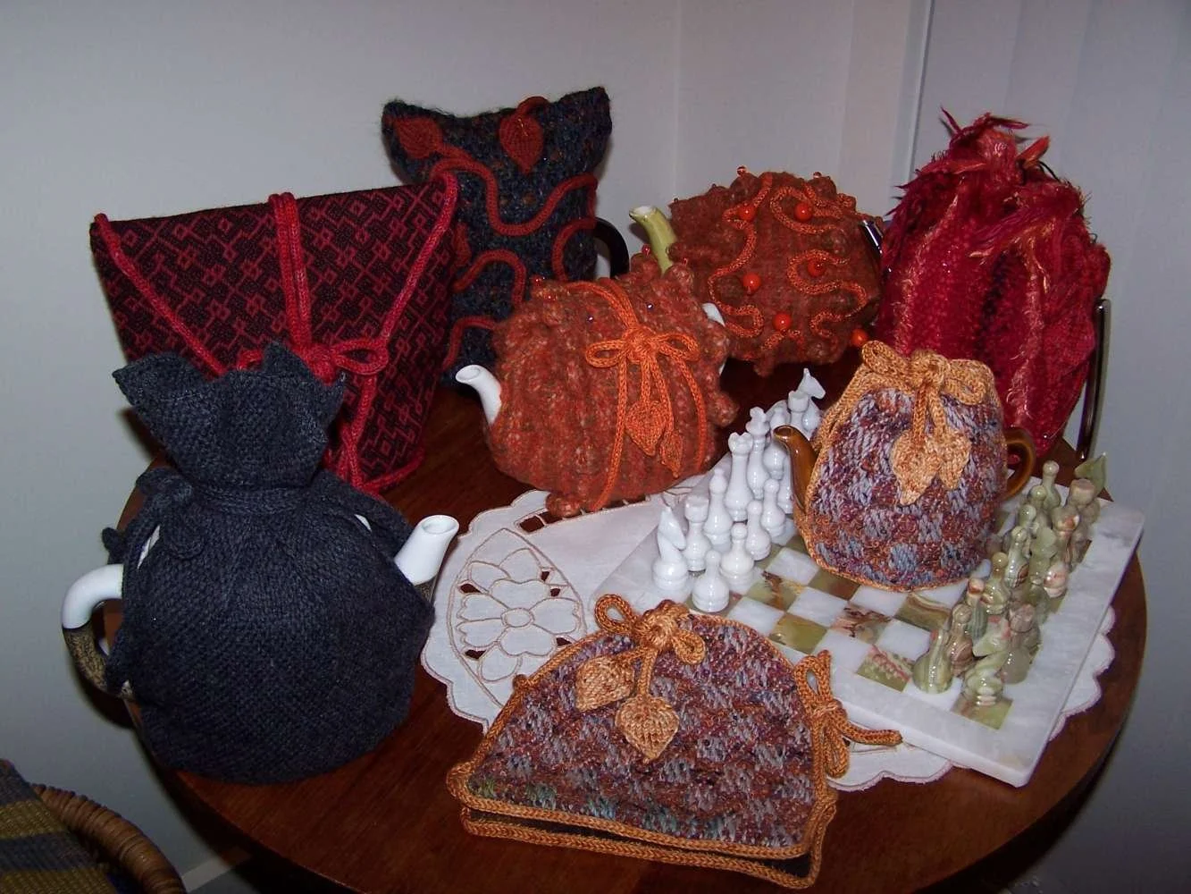 Decorative pumpkins, chess set, and fabric bags on a wooden table.
