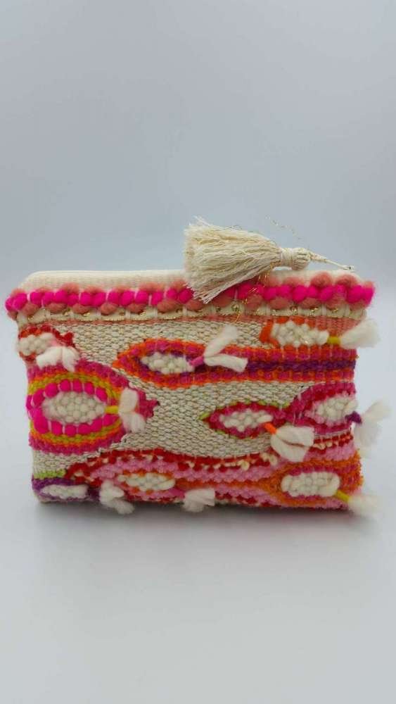 Colorful woven clutch purse with pom-pom decorations and a tassel on top.