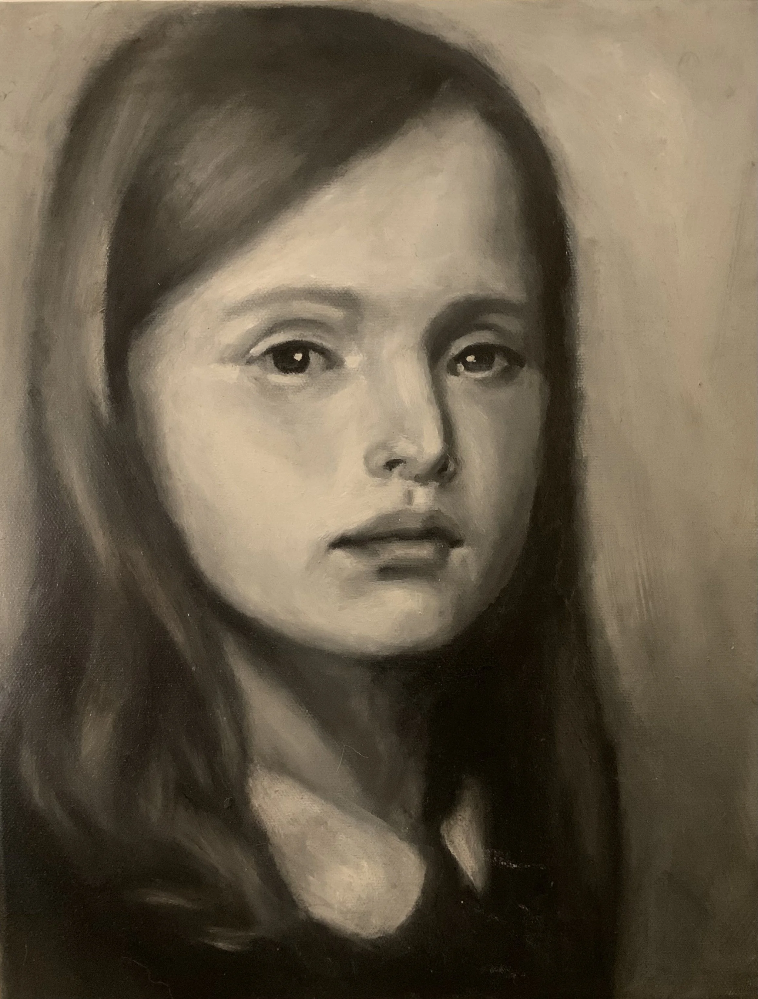 A black and white portrait of a woman with long hair, looking slightly to the side.
