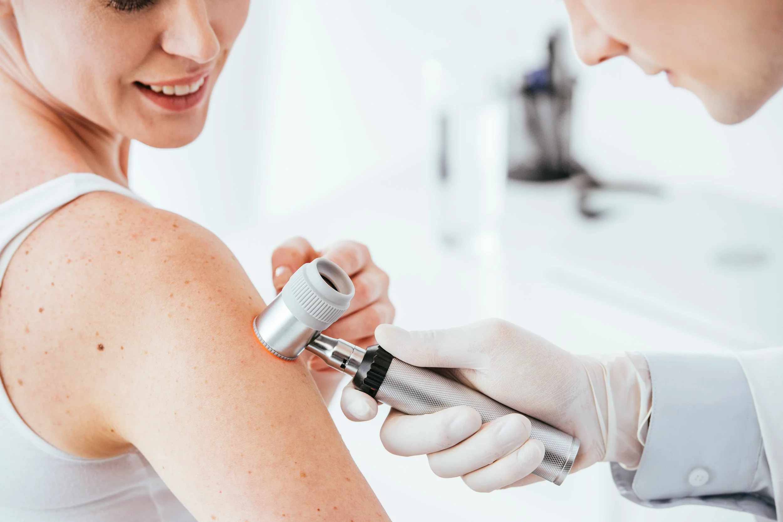 A nurse or doctor administering a flu shot to a woman in a medical setting with a bright, sterile background.