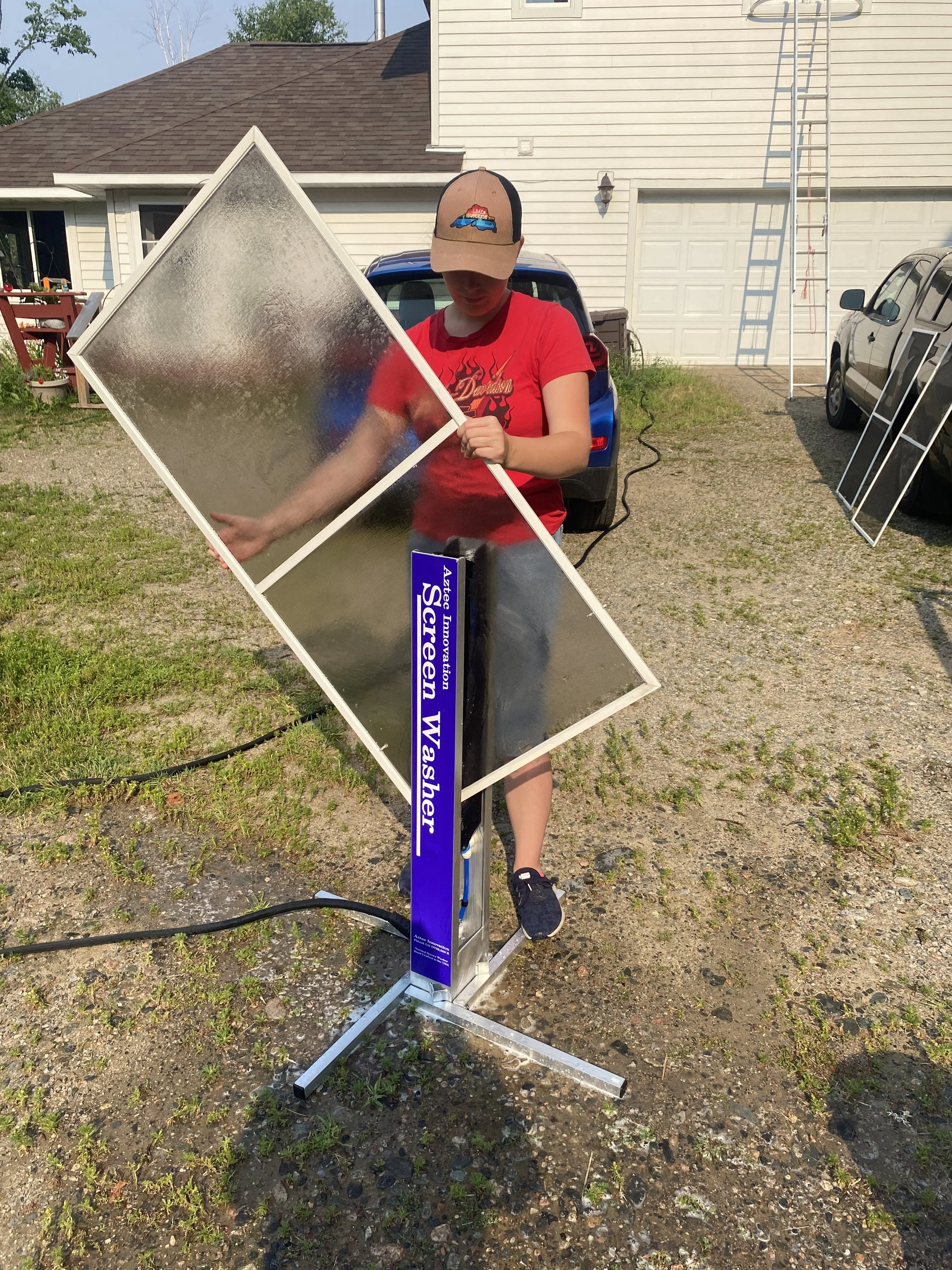 A person using a specialized window screen cleaner
