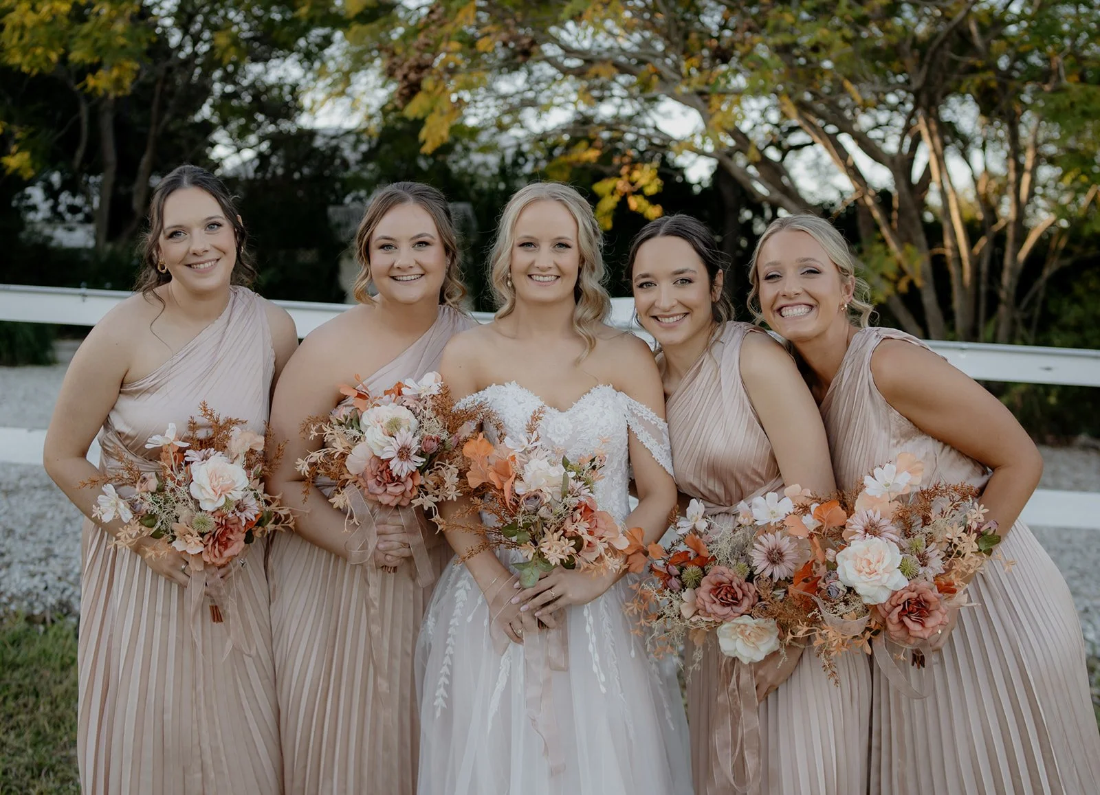 Blonde bride with bridal party hair and makeup and stunning flowers