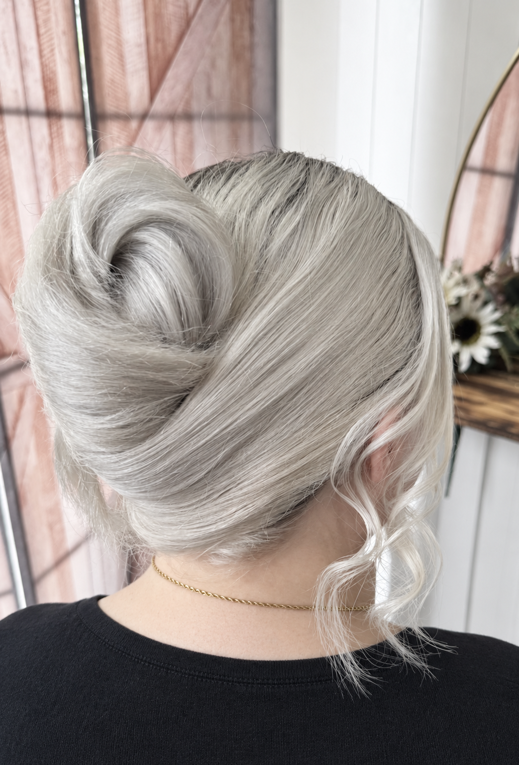 platinum blonde French twist with volume and front waved fringe