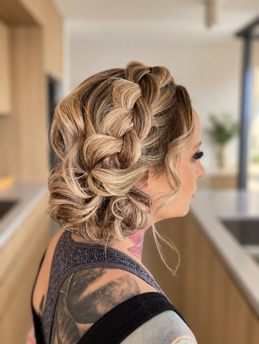 bridesmaid chunky pull apart braid on the side, low bun on blonde highlighted hairs adds texture and dimension