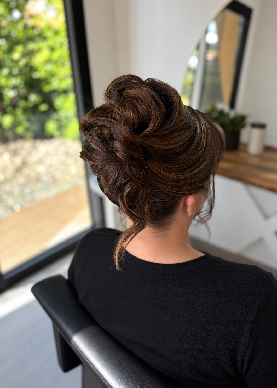 mother of the bride with a high textured dark brown up style modern twist hair do