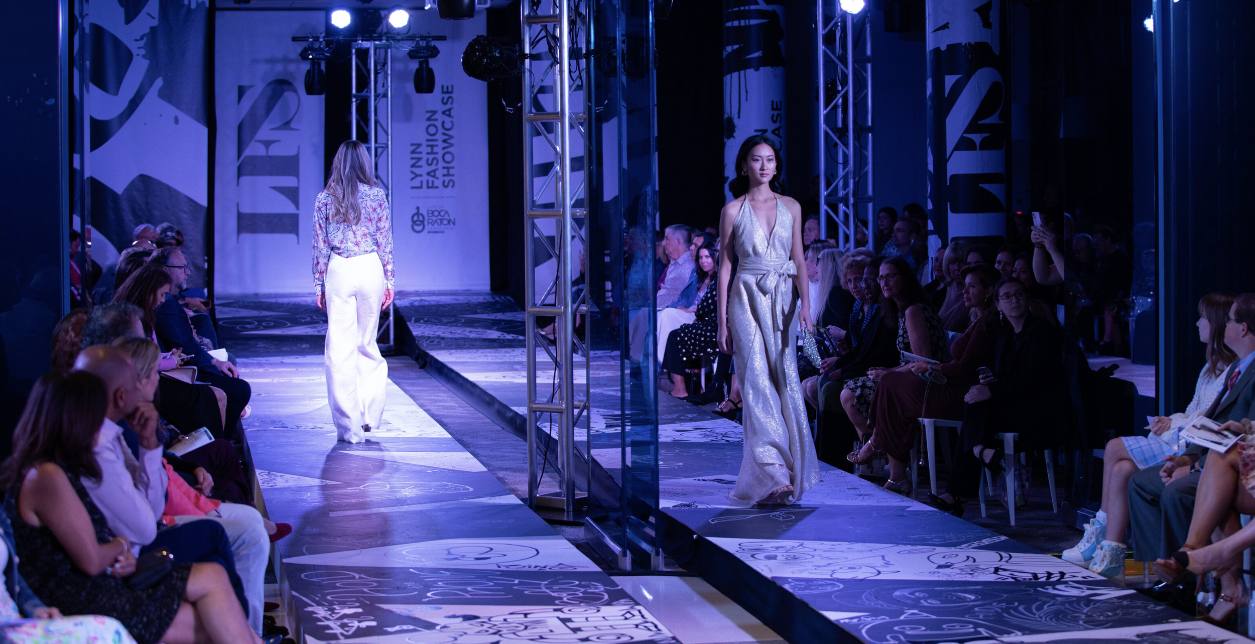 Running a fashion runway show with models walking on the runway and seated audience watching.