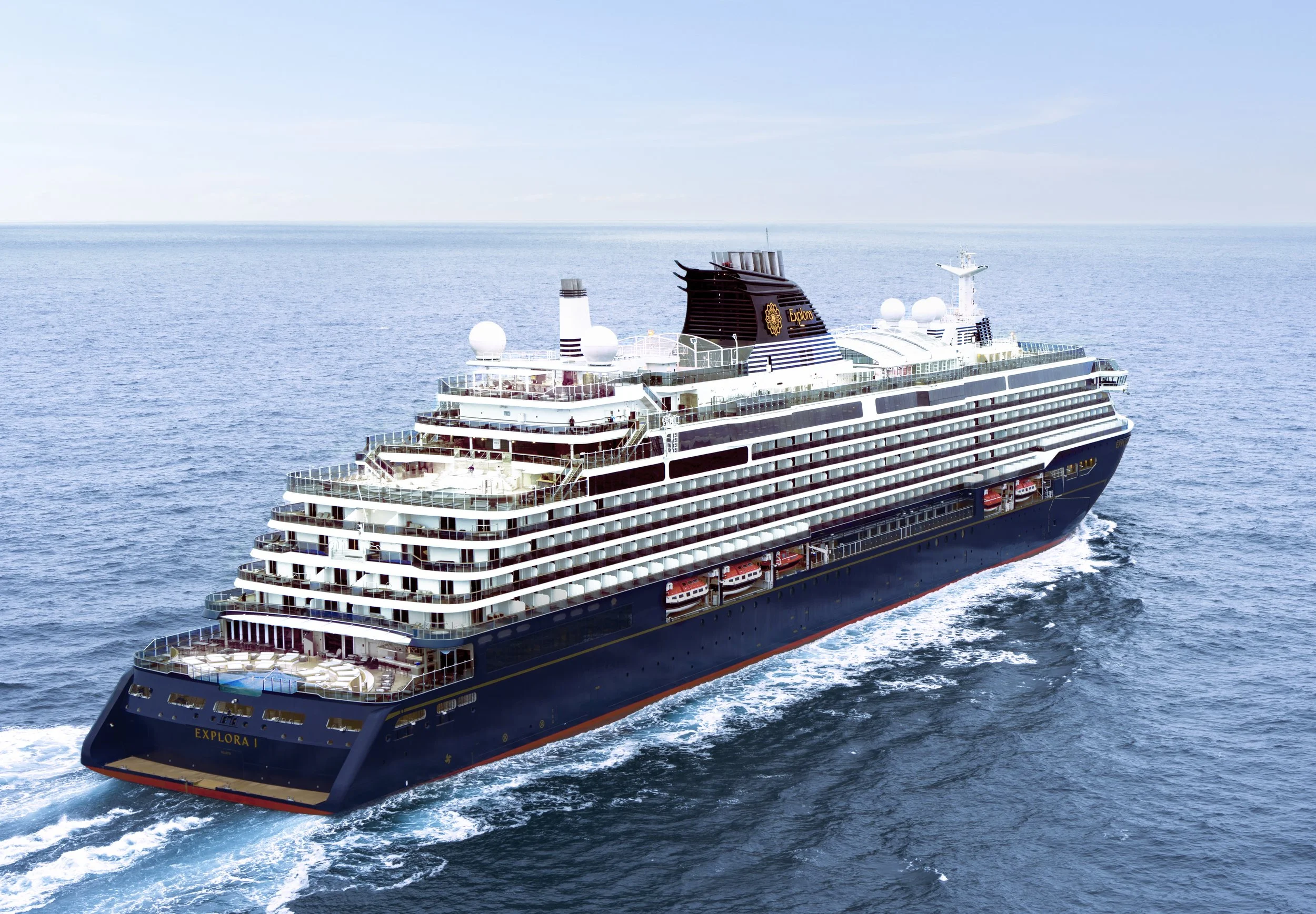 Cruise ship named Explore I sailing on the ocean with a clear blue sky.