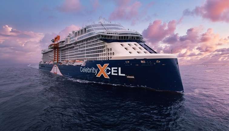 A large cruise ship named Celebrity Xcel sailing on the open ocean during sunset with pink and purple clouds in the sky.