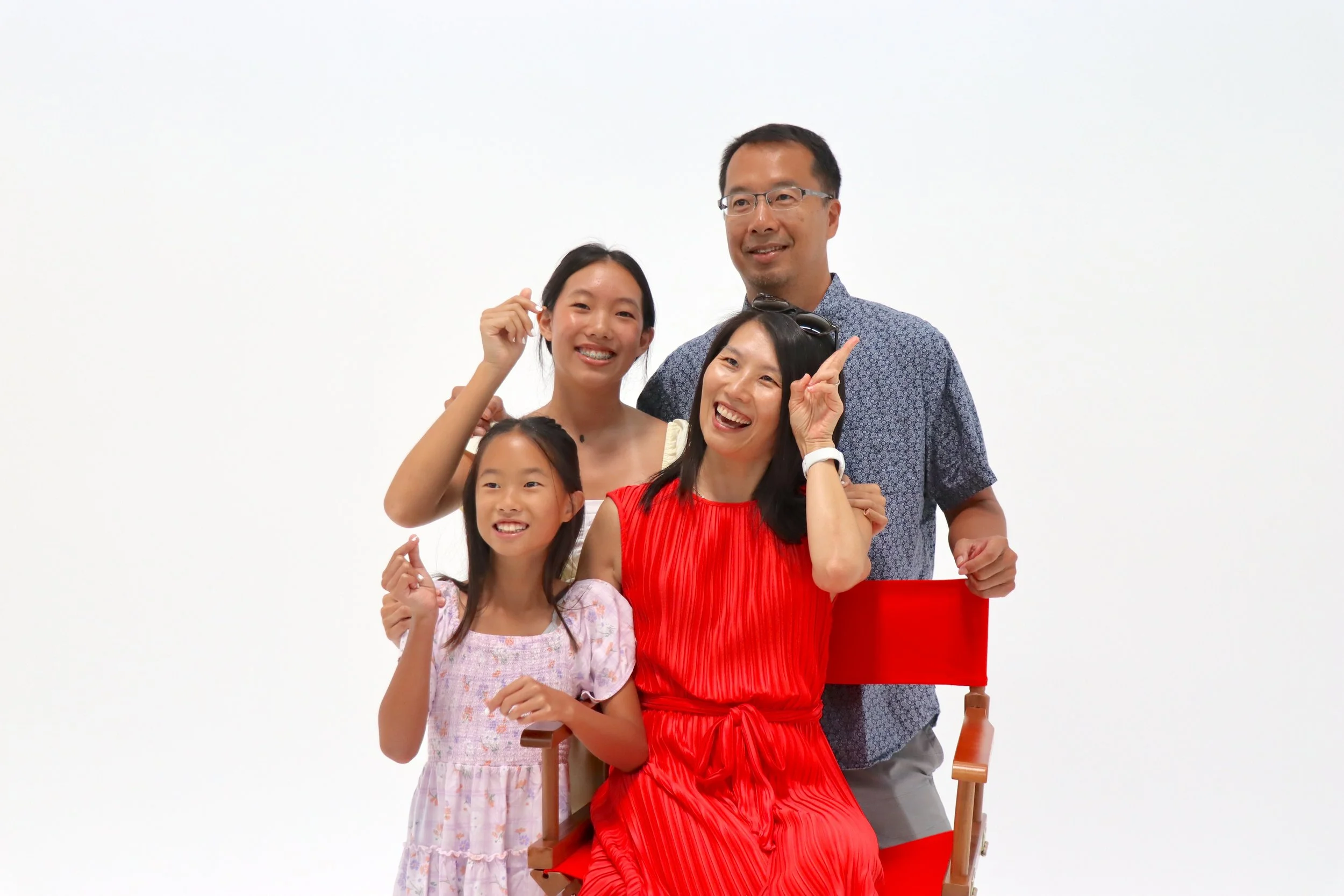 A family posing on the white cyc