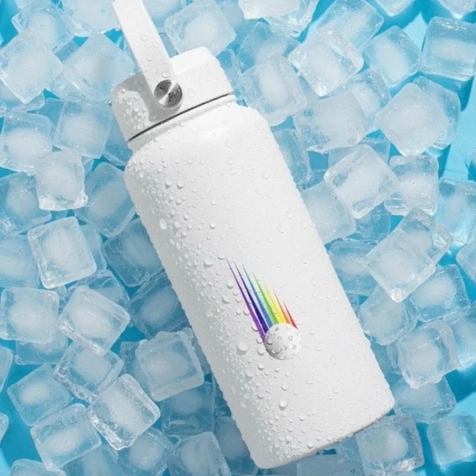 Rainbow Pickleball double-walled 1 litre Water Bottle by Pickleball Merch Aus, sitting in the middle of an ice bucket