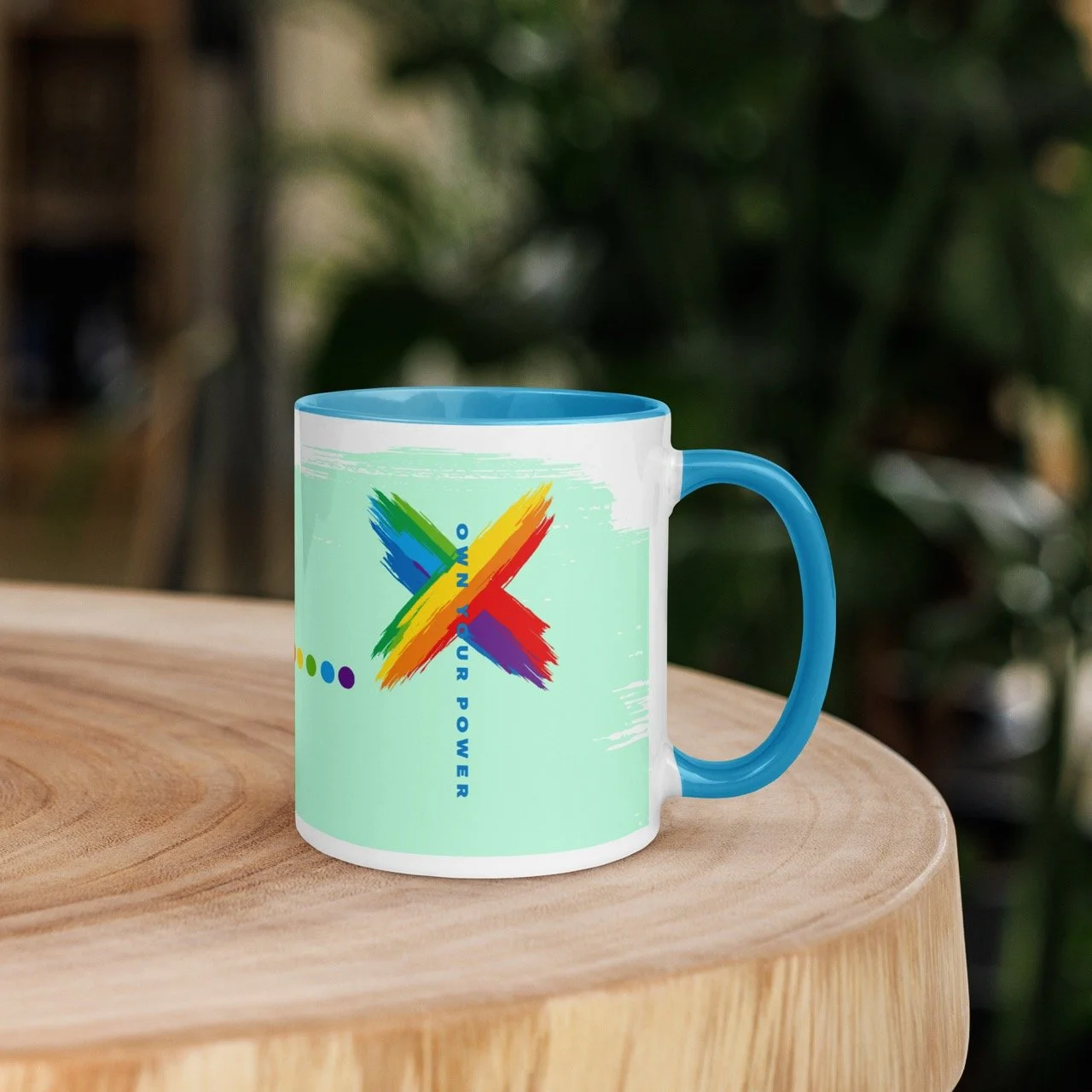 Own Your Pride Power Mug by Pickleball Merch Aus, sitting on a wood table outdoors