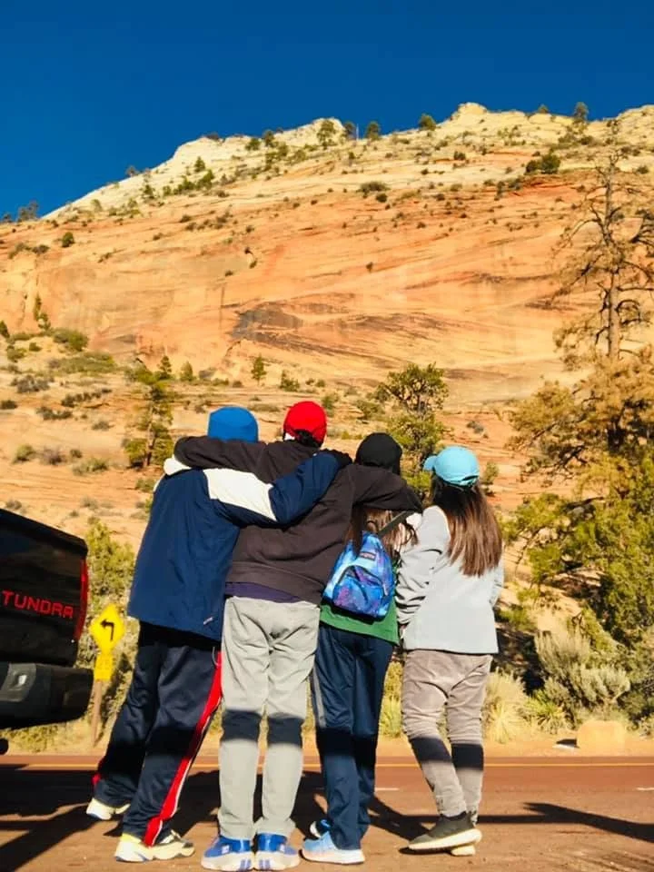 zion-family-facing-red-cliffs.jpg