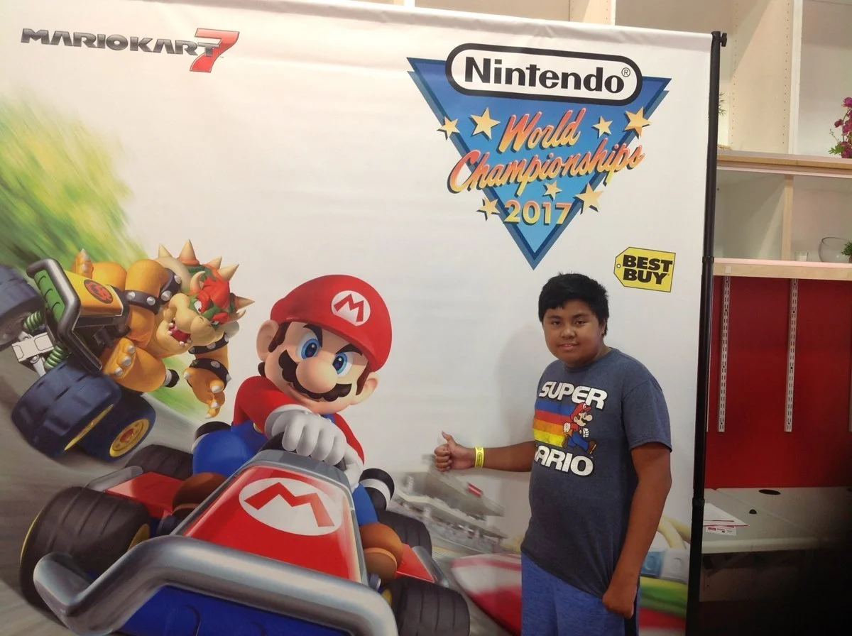 My son at Nintendo New York, with the Mario Kart display.