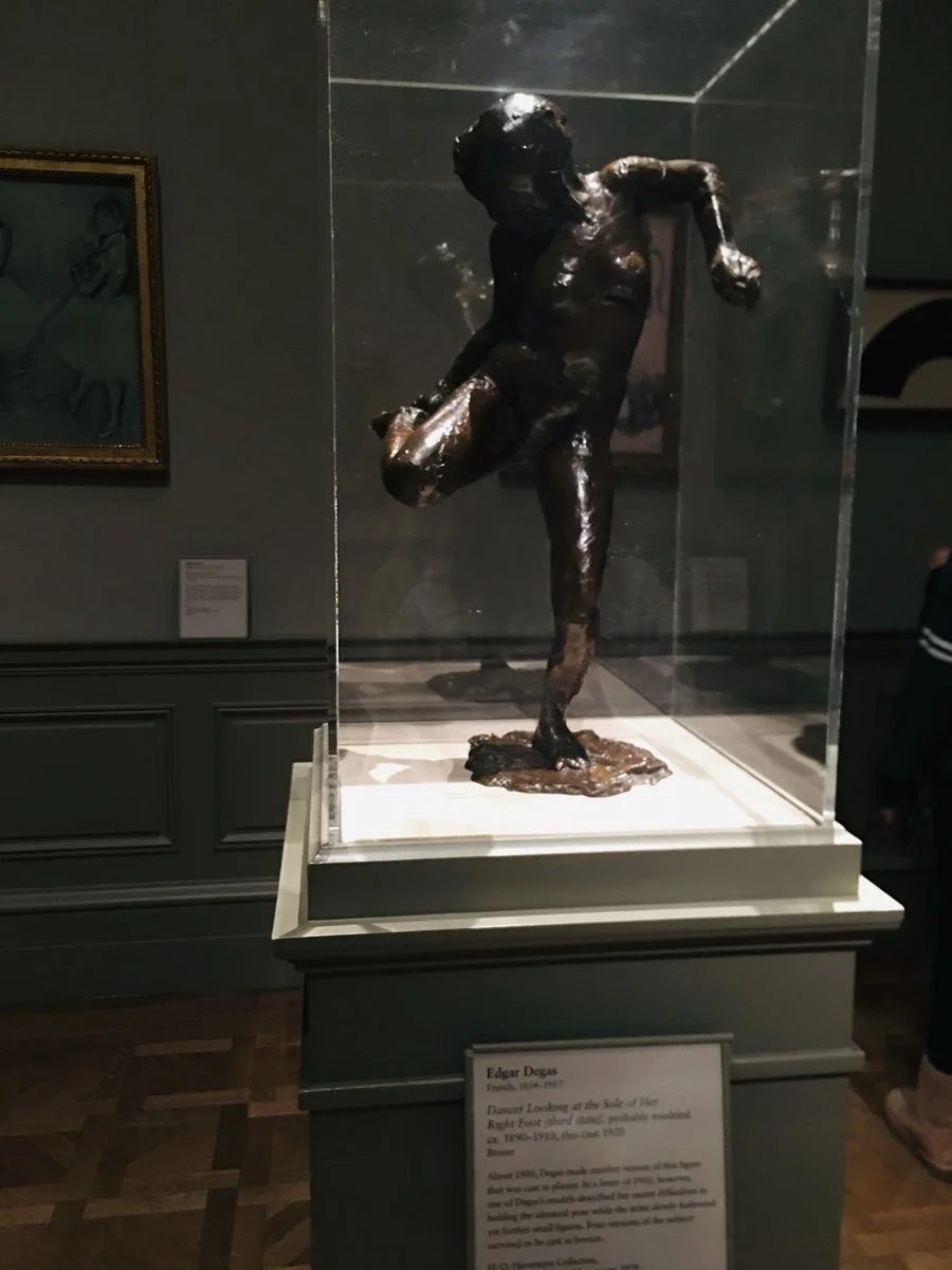 Looking closely at art during a NYC museum visit.