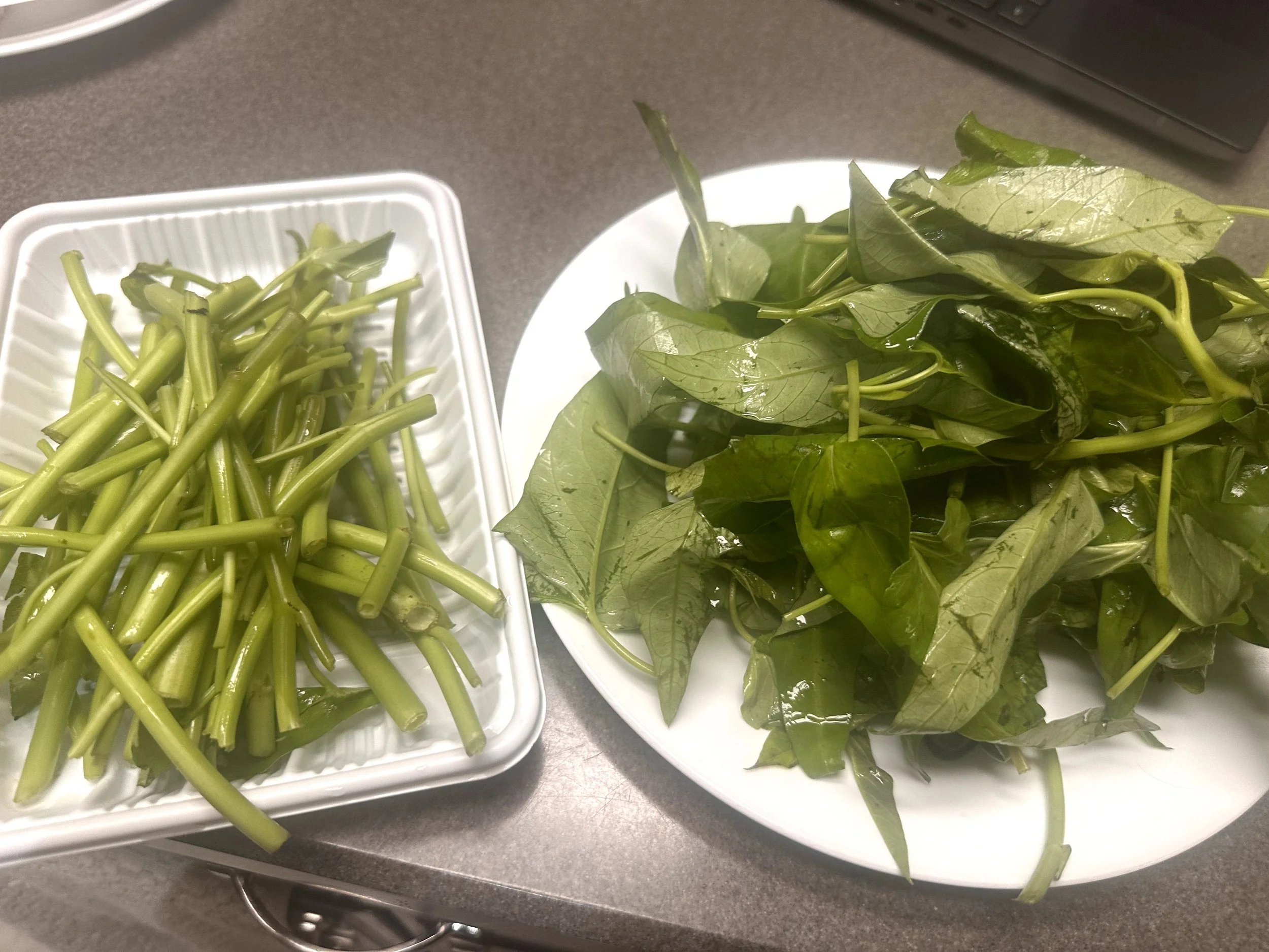 Homemade kangkung belachan with shrimp, tomatoes and dried chilies