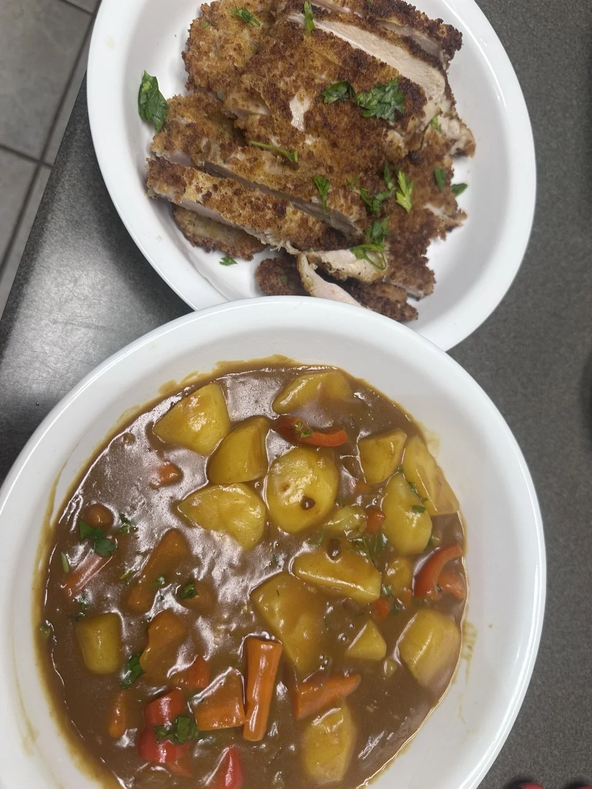 Homemade chicken katsu and Japanese vegetable curry served on separate platters.