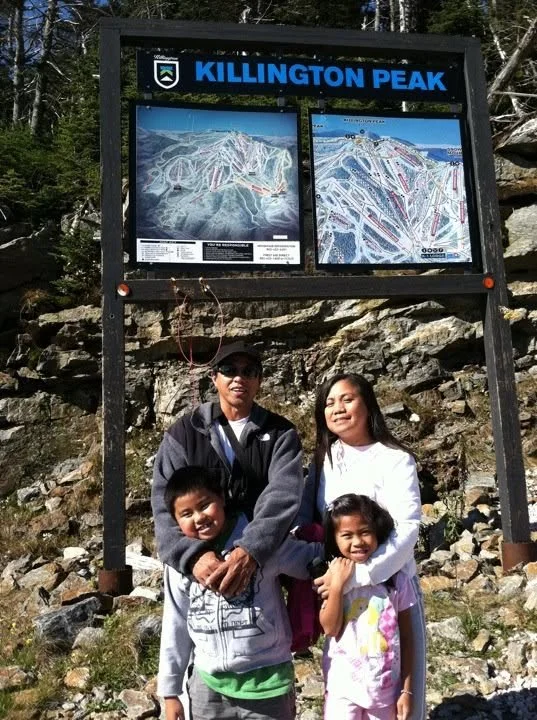 Our family standing beneath the Killington Peak trail sign in Vermont in October 2011, an original photograph from our New England travels.