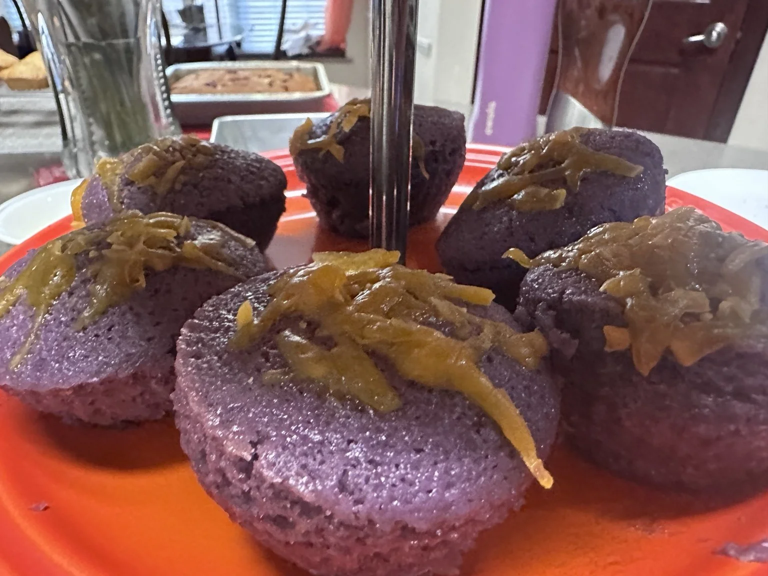 Close-up of purple ube puto topped with melted cheese