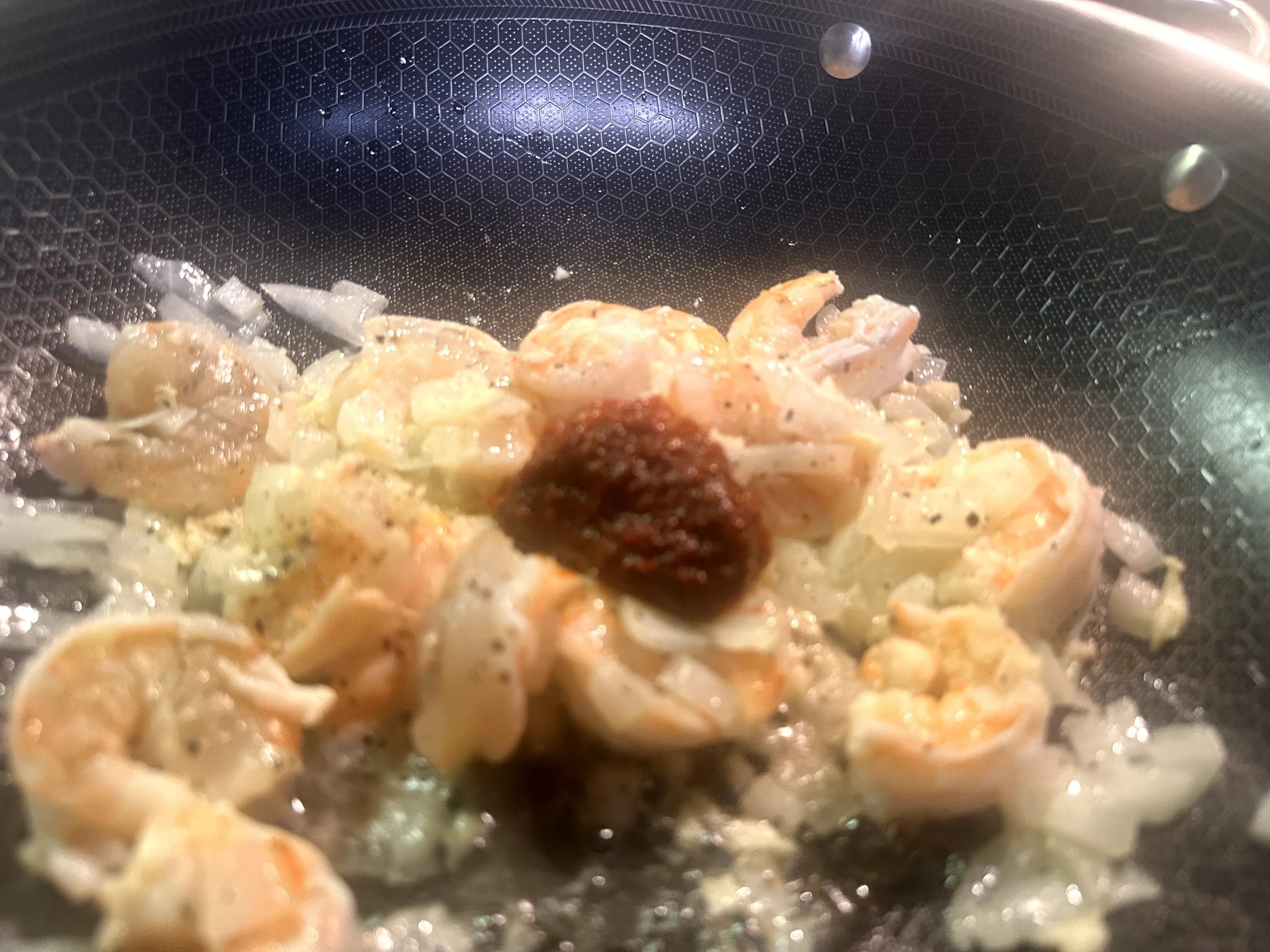 Medium to large shrimp cooking with belachan paste, garlic and chili
