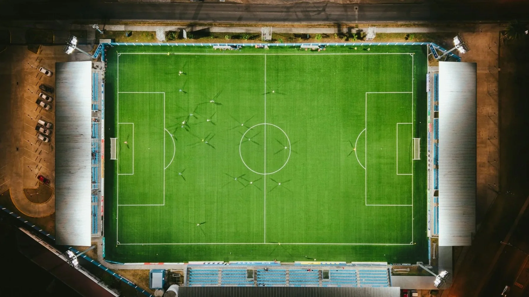 Aerial view of a floodlit football pitch seen from directly above