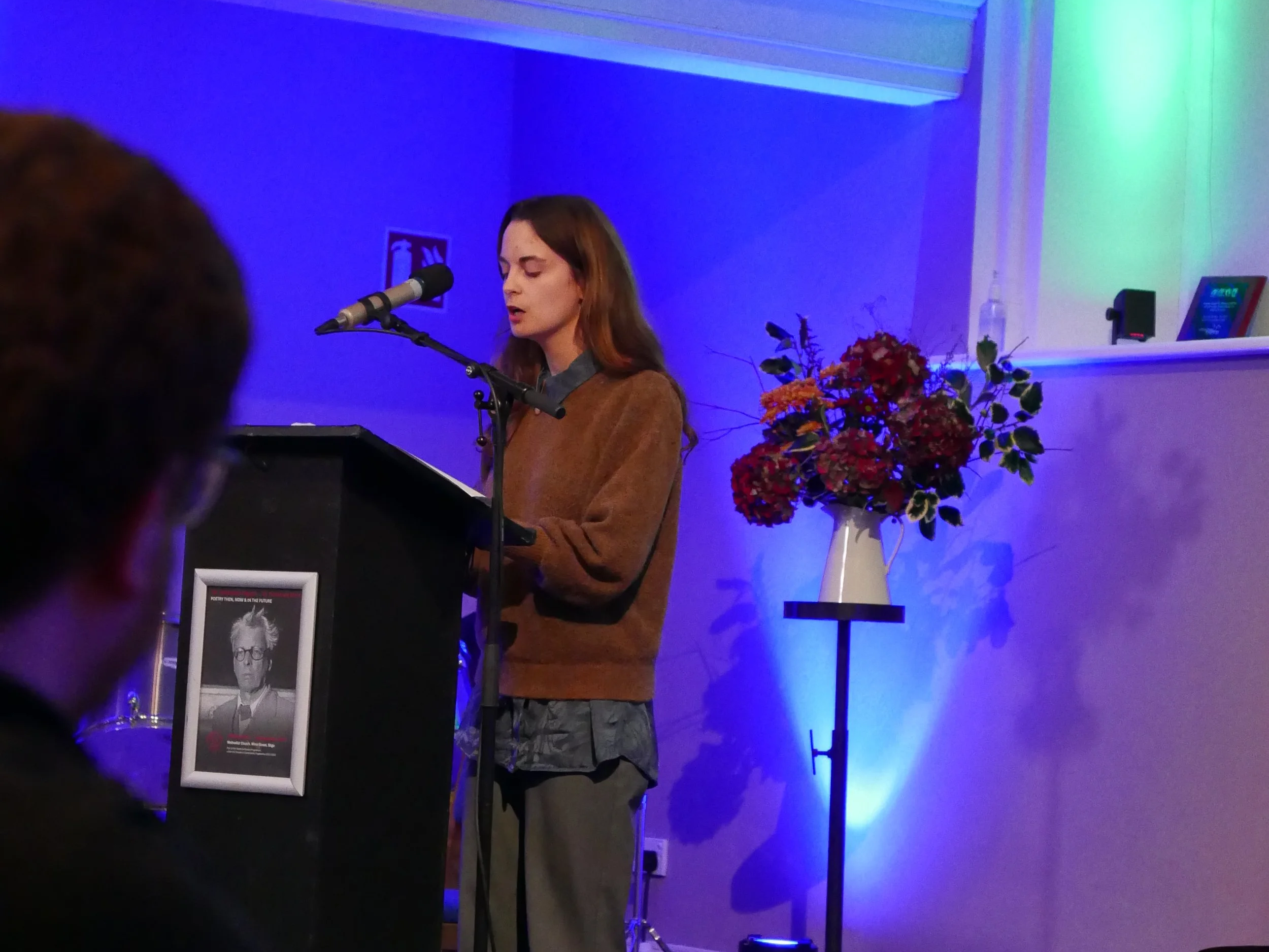 Reciting original poetry, "From Dust to Soil", at the WB Yeats Nobel Centenary (Sligo, 2024).