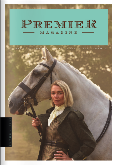 Magazine cover titled 'Premier Magazine' featuring a woman with blonde hair standing next to a white horse outdoors, with trees in the background.