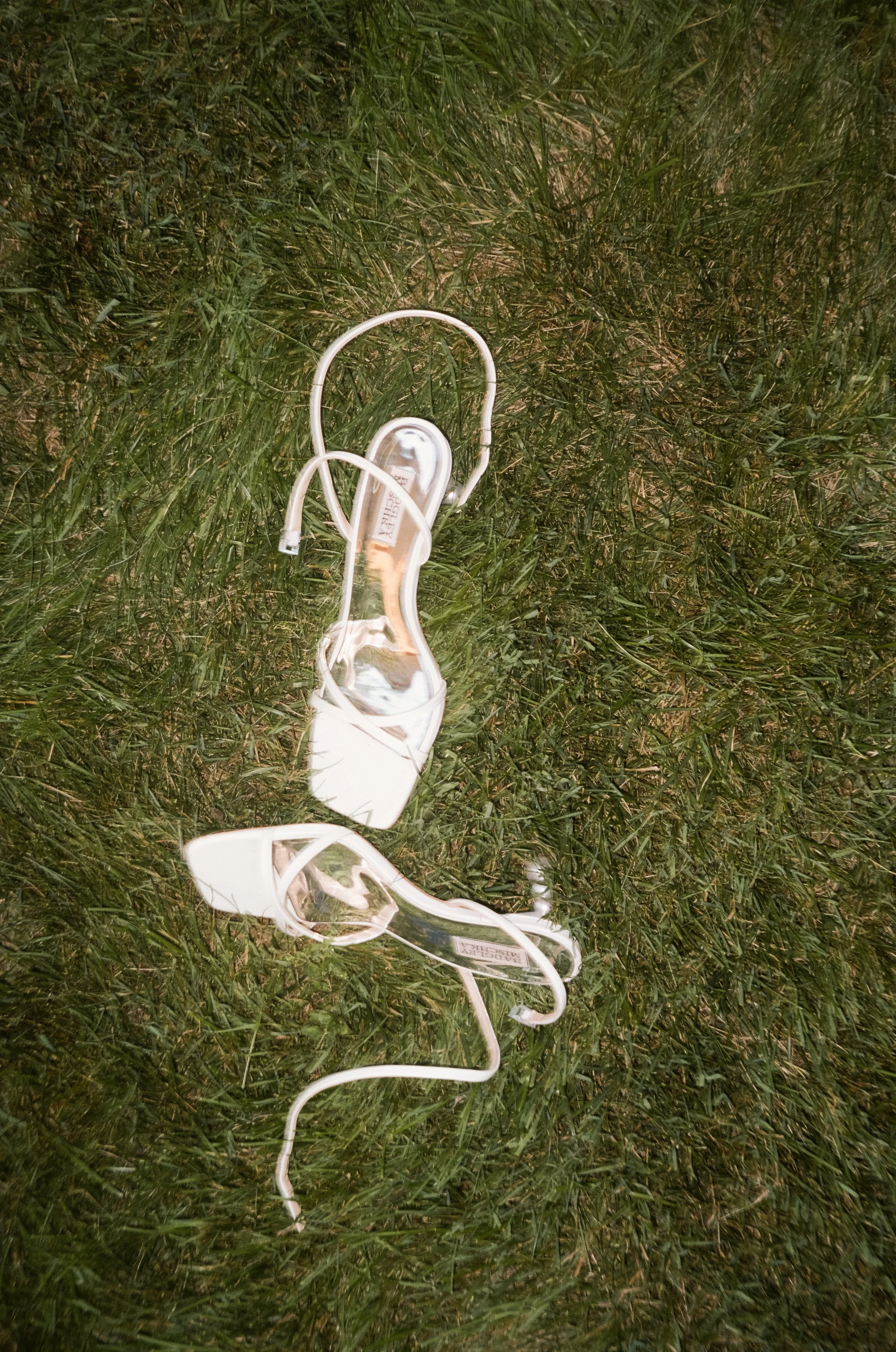 A white, tangled plastic electrical cord lying on green grass at night.