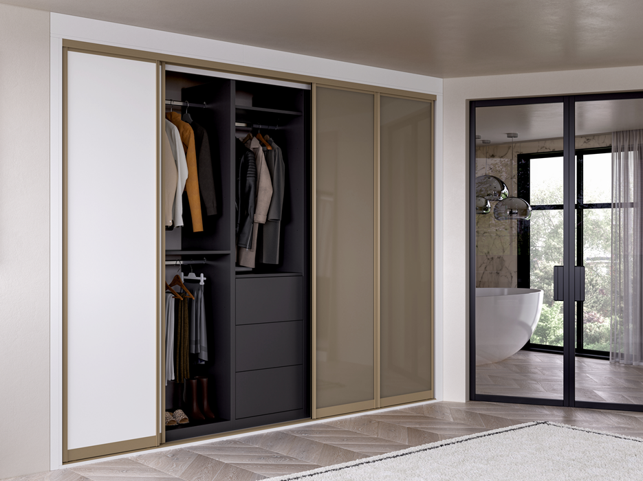 A modern closet with sliding doors and an adjacent bathroom with a freestanding bathtub and large windows.