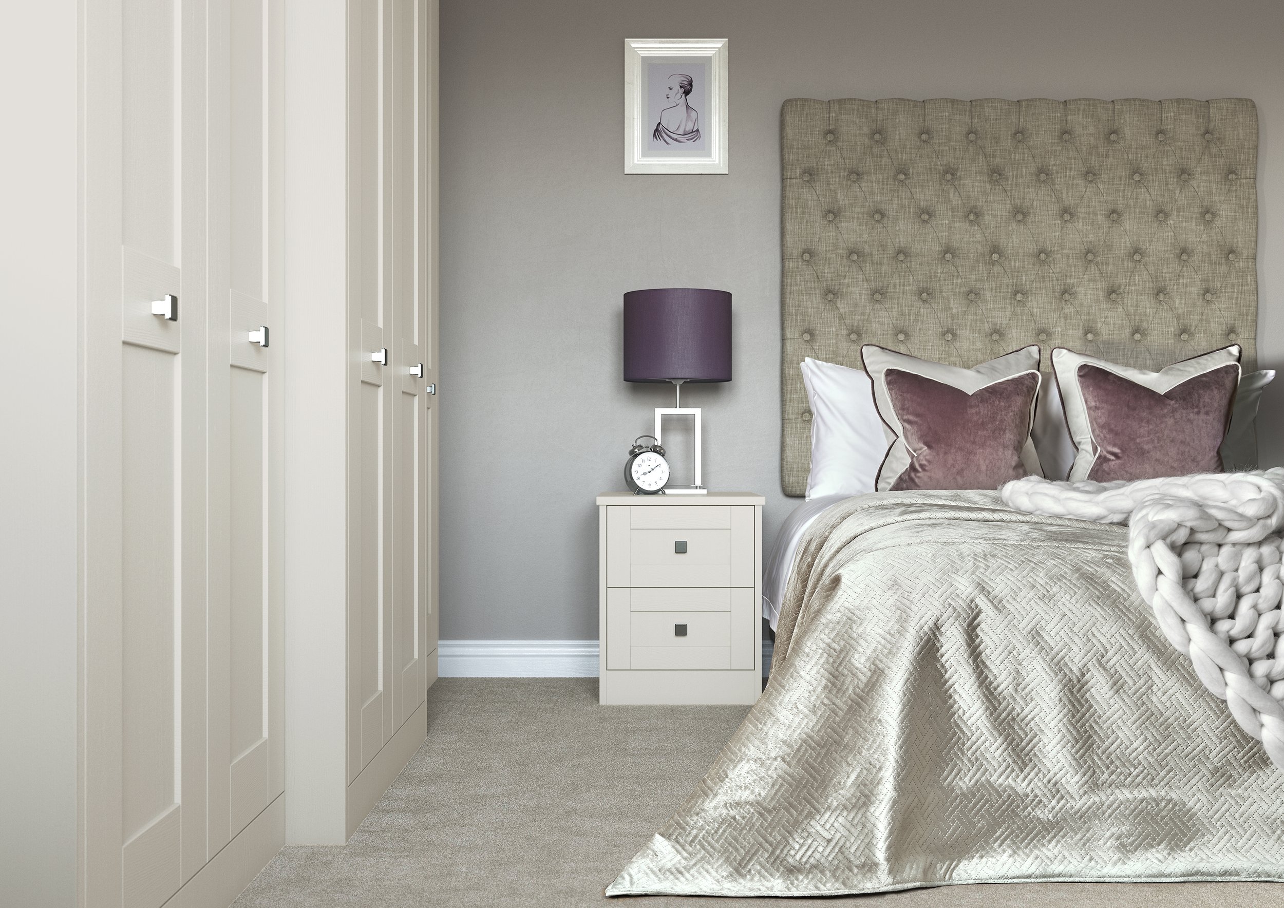A cozy bedroom with a large upholstered headboard, white bed linens, and plush pillows. There is a nightstand with a purple lampshade, a small clock, and framed artwork of a woman's portrait on the wall. A white closet with multiple doors is on the l