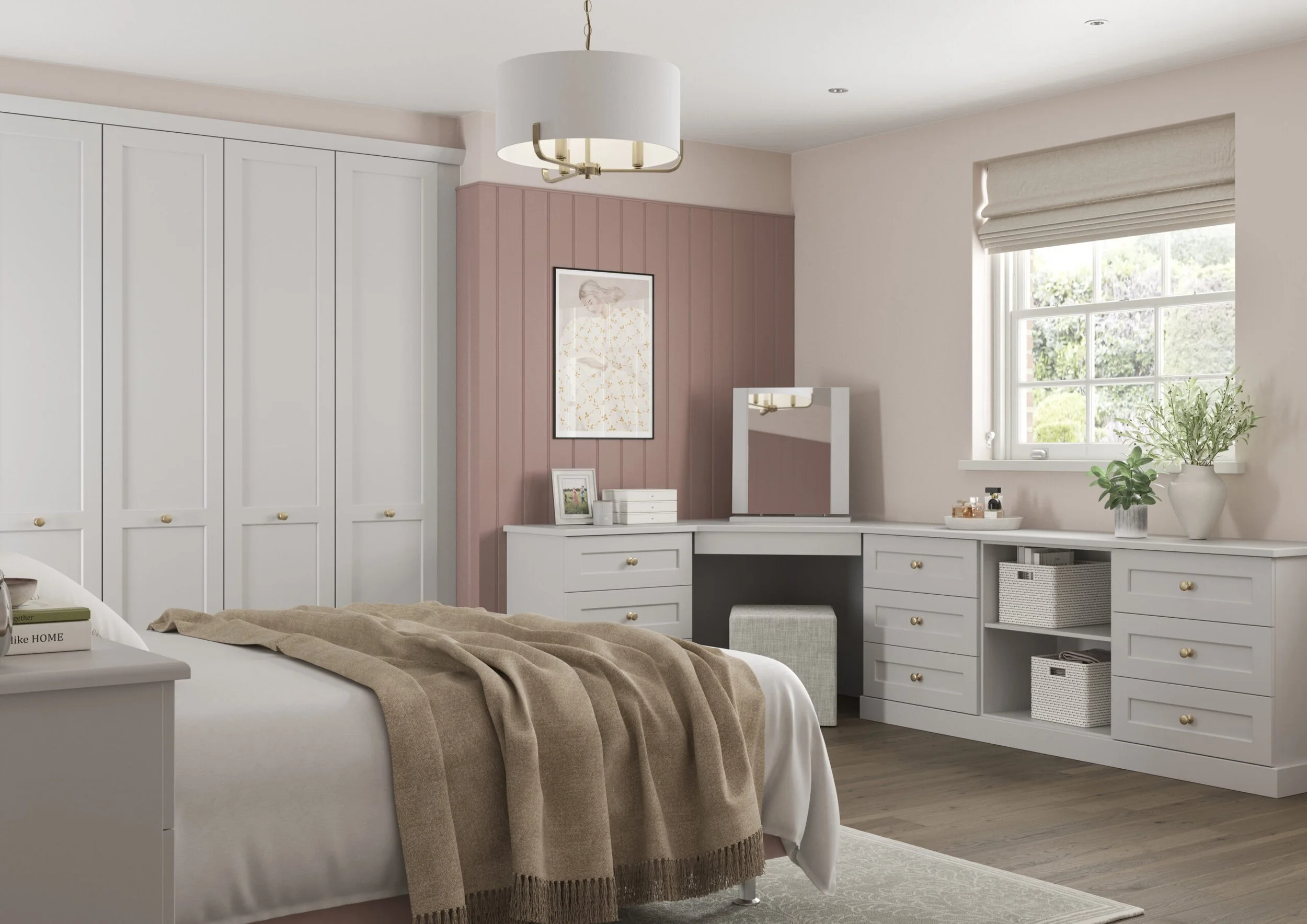 A cozy bedroom with a white bed, beige blanket, white nightstand with books, a built-in white desk and drawers, a large window with beige blinds, a potted plant, and a pink accent wall with a framed artwork.