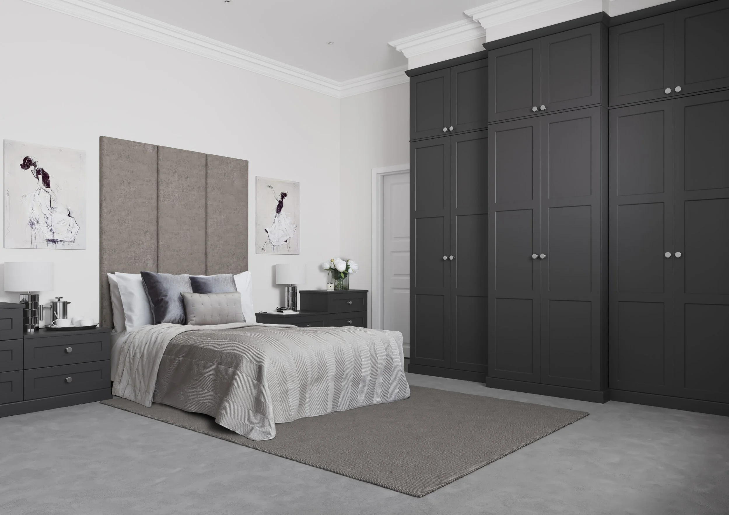 A bedroom with a large bed, gray headboard, white bedding, and pillows, flanked by matching gray nightstands with lamps, and a tall dark gray closet with multiple doors.