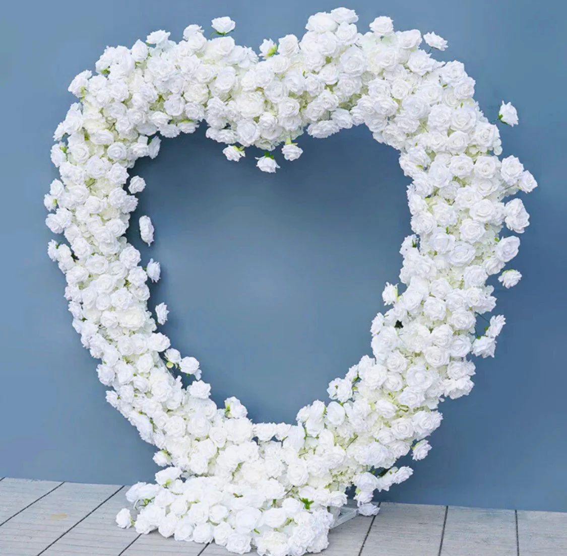 White floral heart-shaped wreath backdrop for wedding or proposal