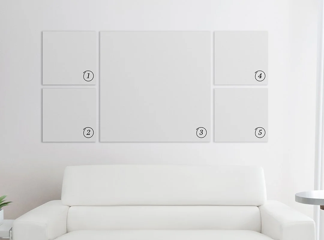 A white sofa in front of a wall with five blank white square boards numbered 1 to 5